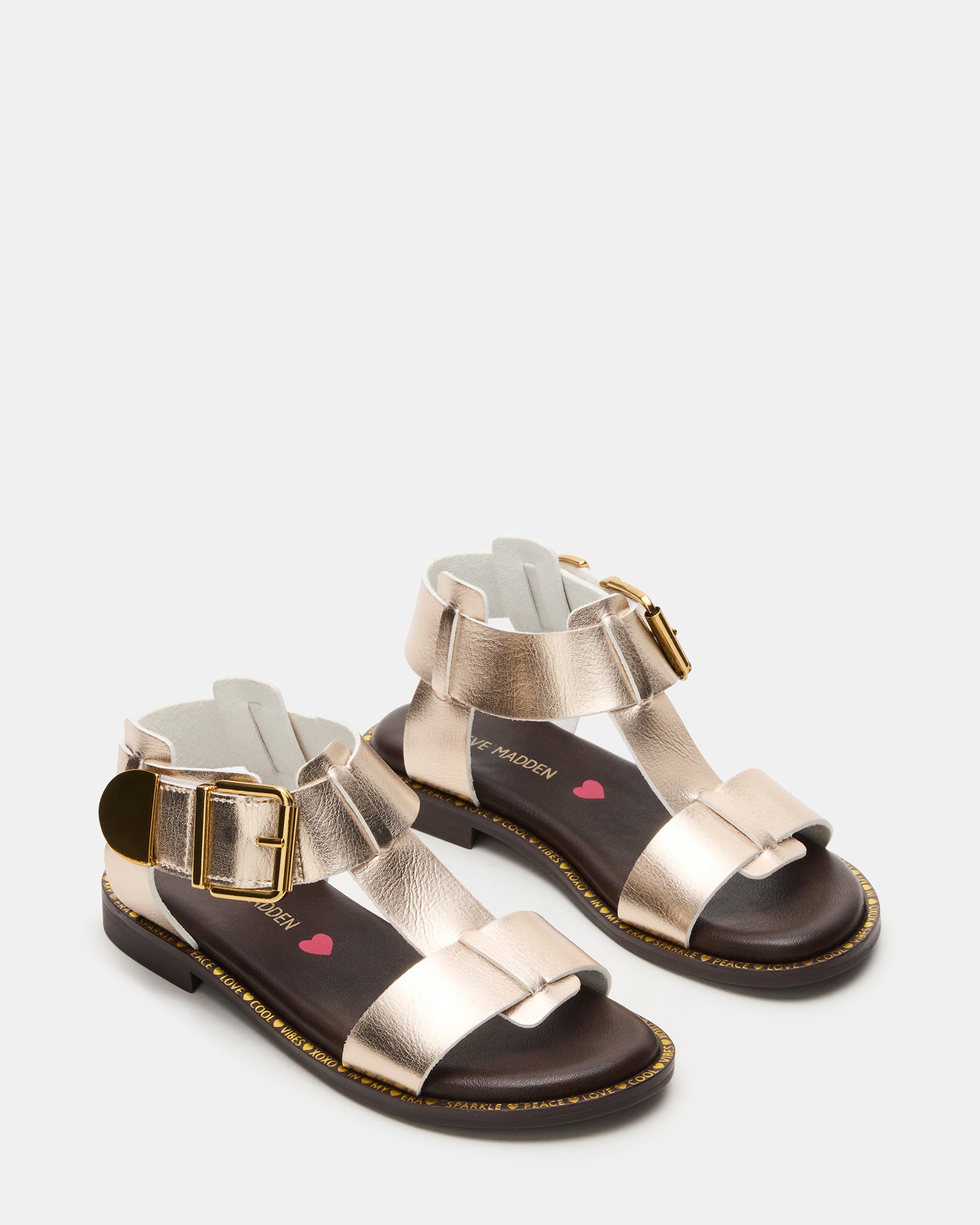 Side profile of kids fashion sandals on gravel path near Wichita