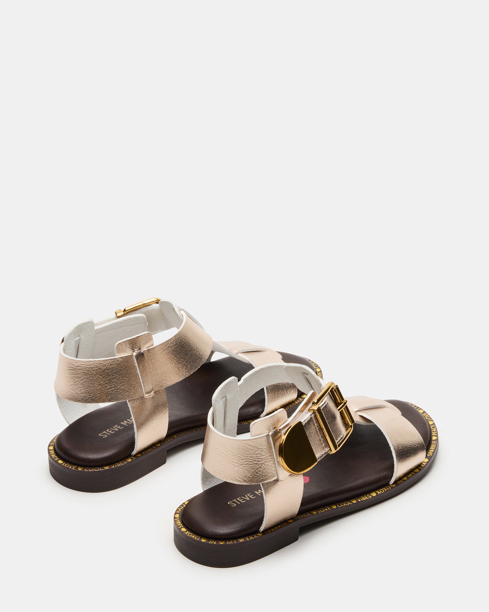 Side profile of kids fashion sandals on gravel path near Wichita