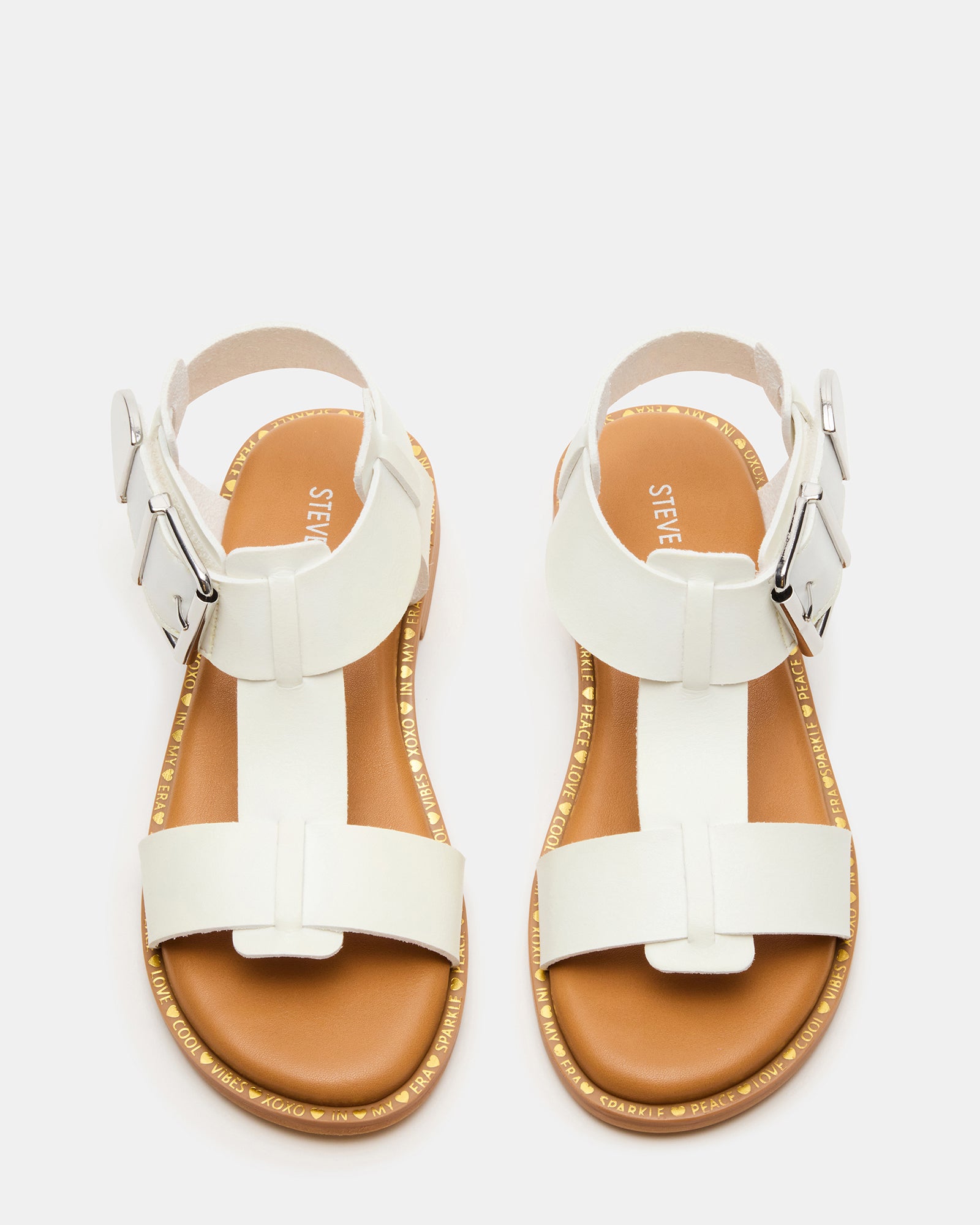 Child wearing white flat sandals at playground