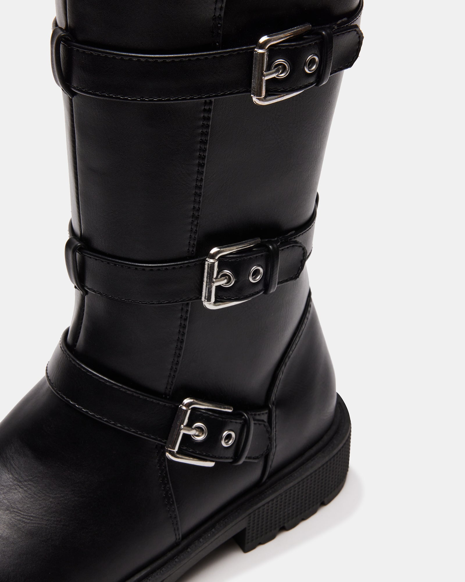 Front angle of black kids knee-high boots with buckle details on wood flooring