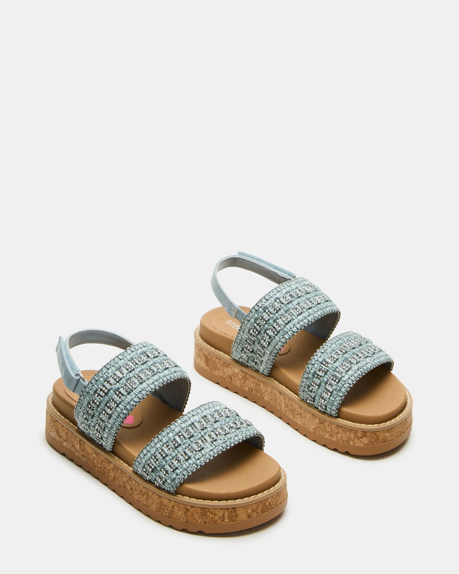 Side view of black platform sandals for kids styled with playful summer attire