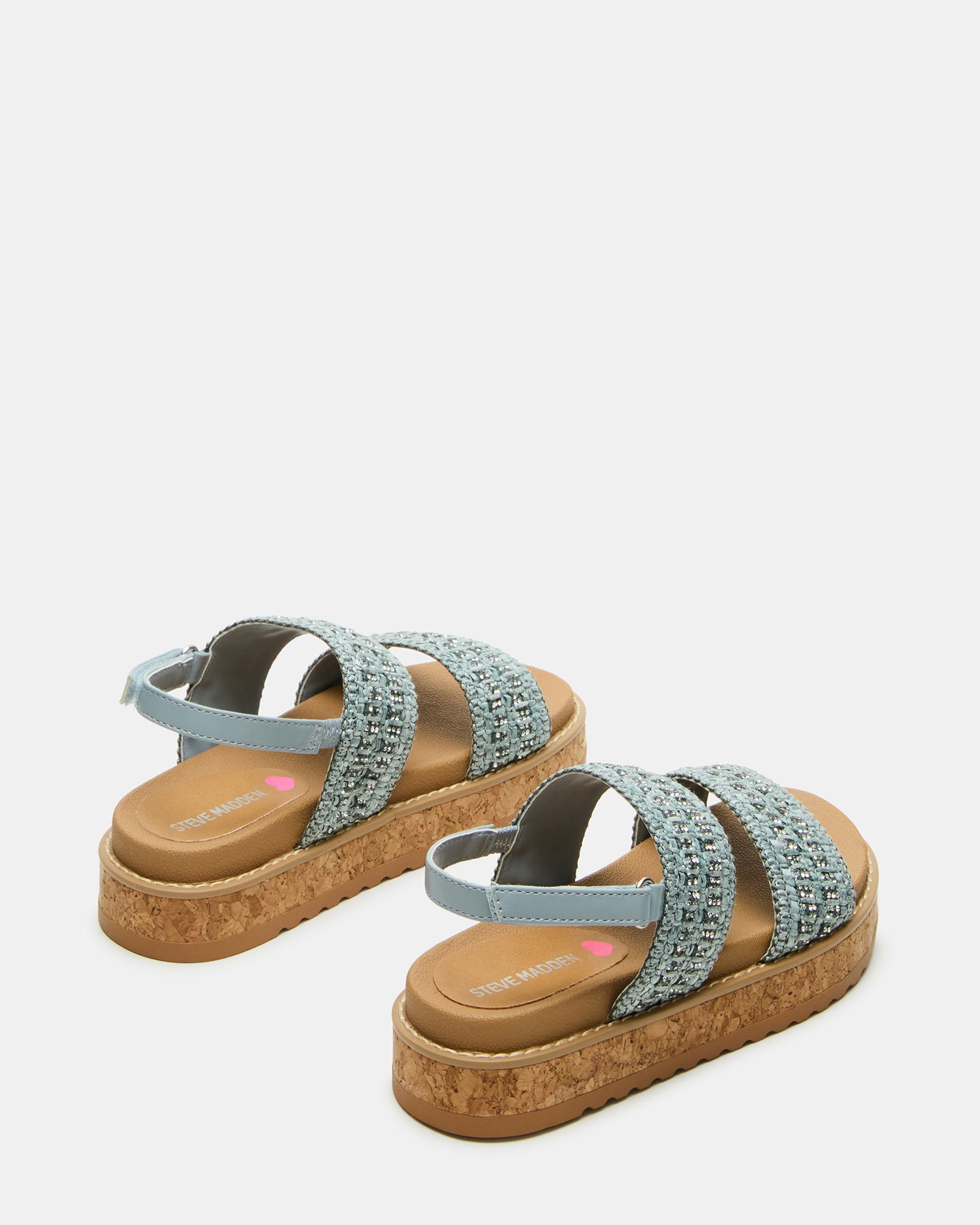 Side view of black platform sandals for kids styled with playful summer attire