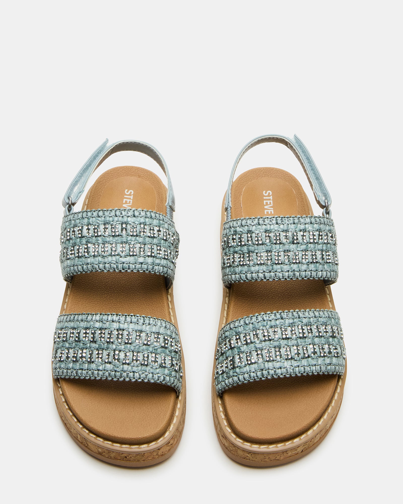 Close-up of woven straps on kids fashion sandals against a NYC backdrop