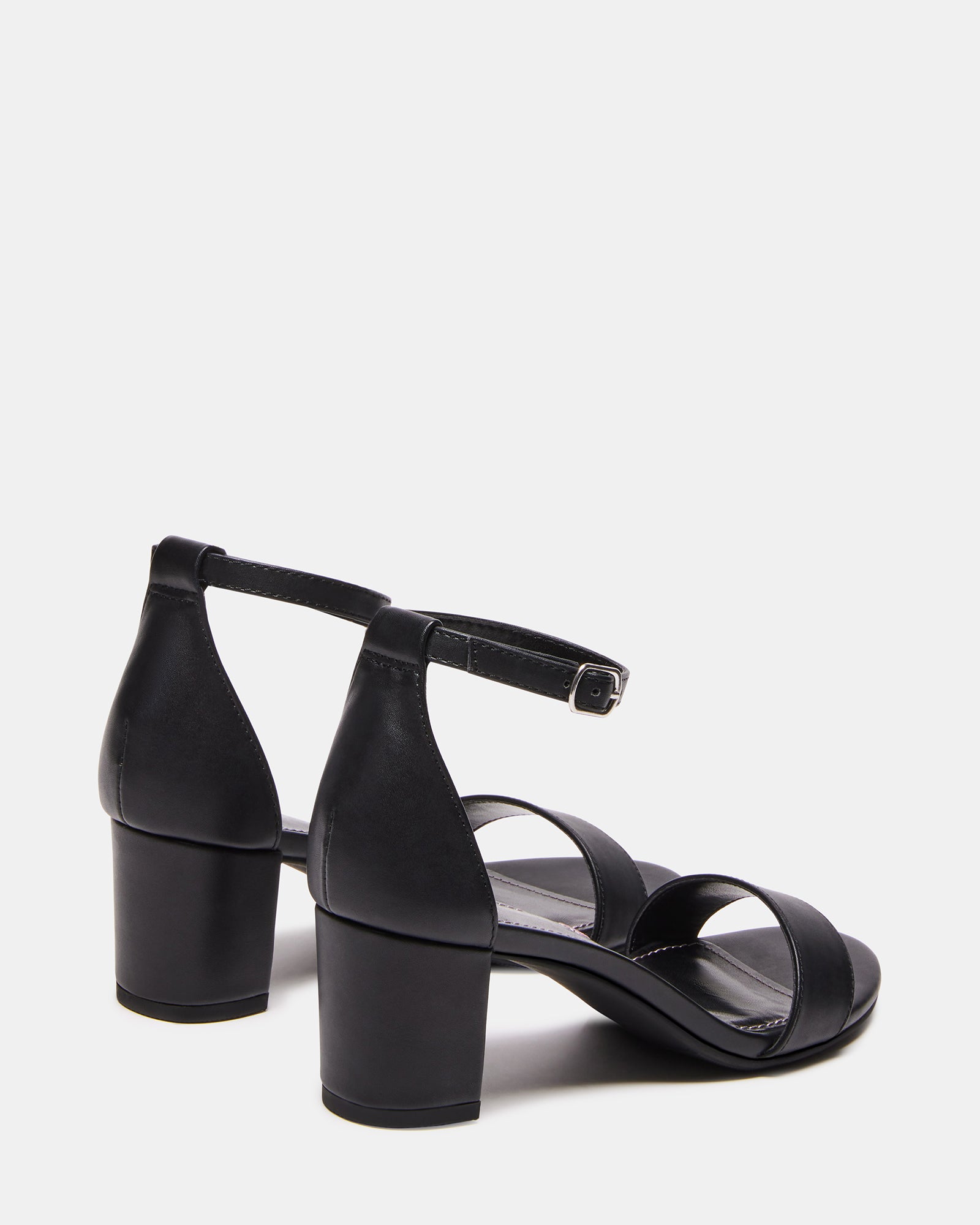 Close-up of buckle closure and smooth synthetic finish on black kids dress sandals