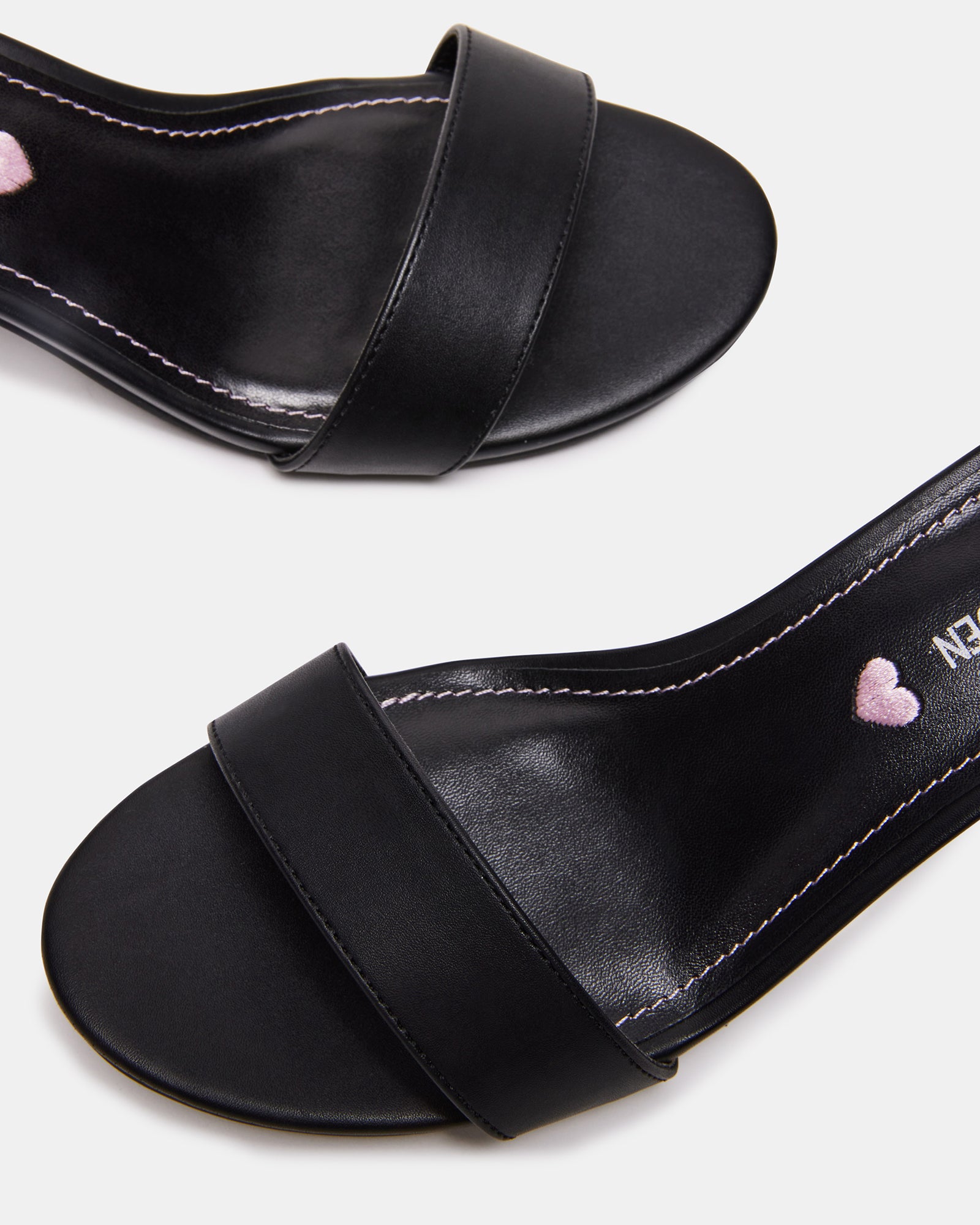 Side view of black kids sandals with block heel and ankle strap, perfect for dressy outfits