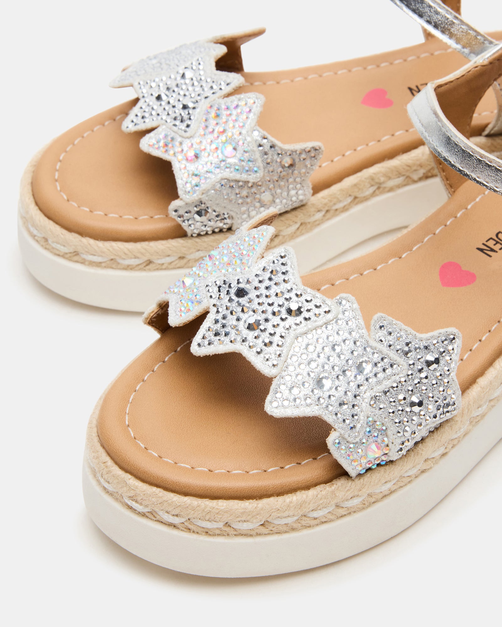 Child wearing sandals on a sunny day, highlighting the glittery details