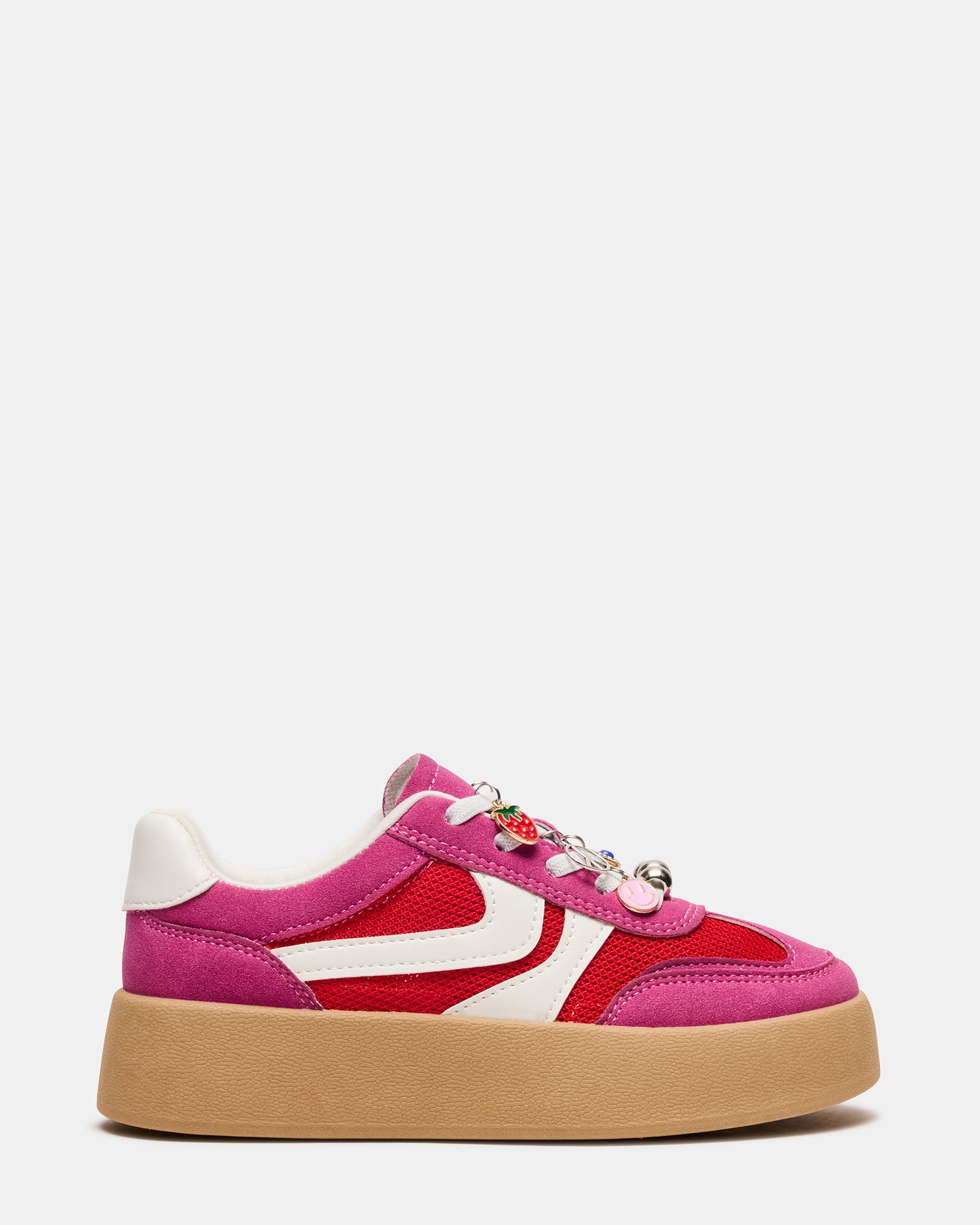 Front-facing view of silver shoes pink sneakers on a child’s feet walking outdoors