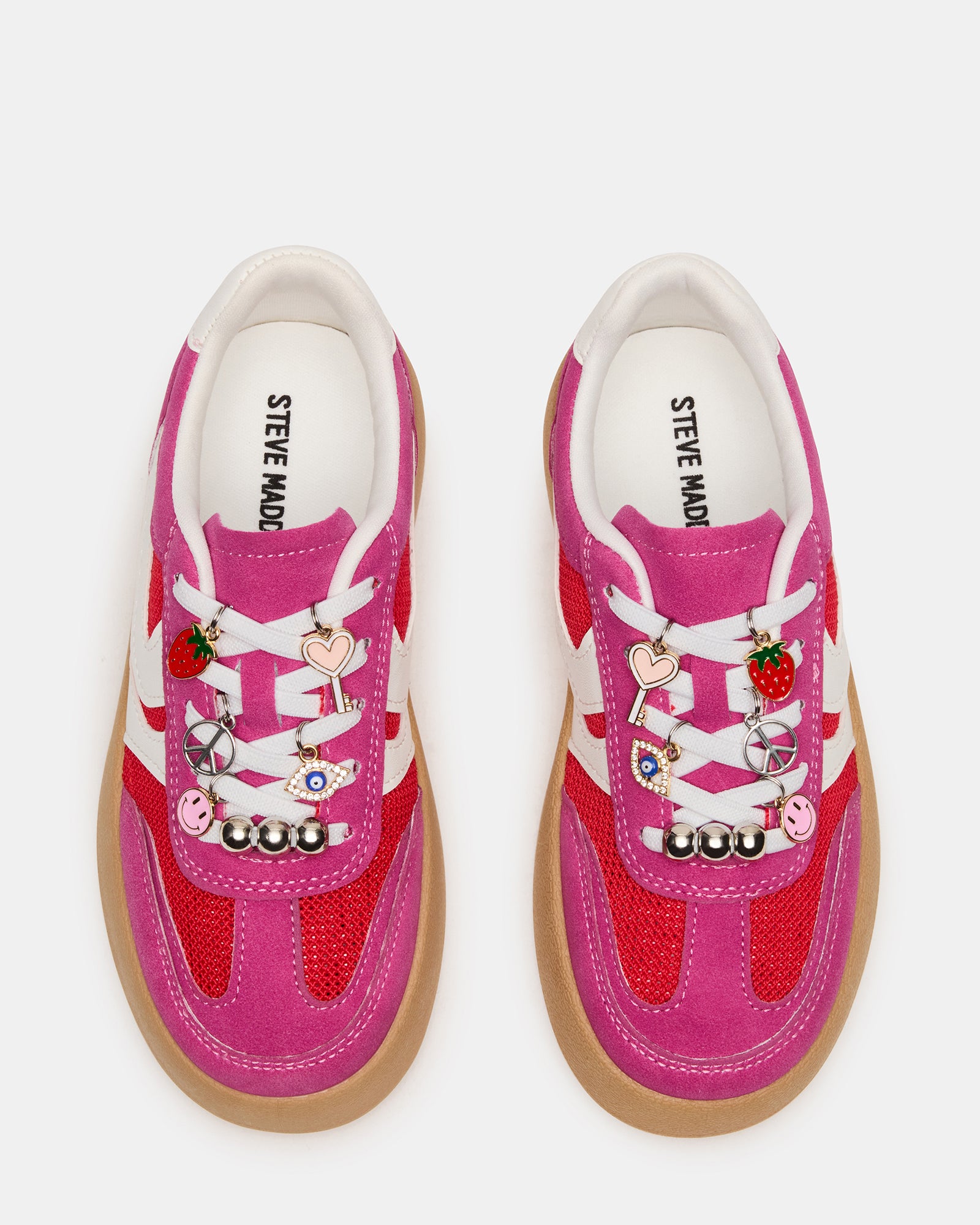 Side profile of pink and green sneakers with platform design and lace charms