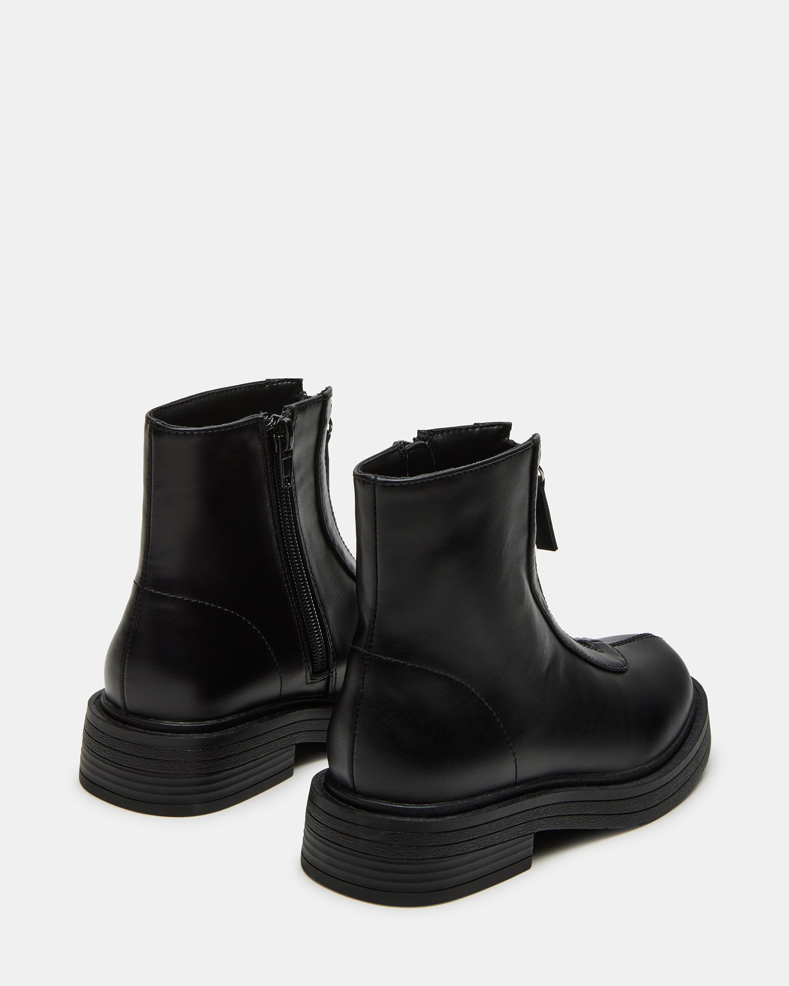 Kids wearing stylish vegan leather ankle boots outdoors.