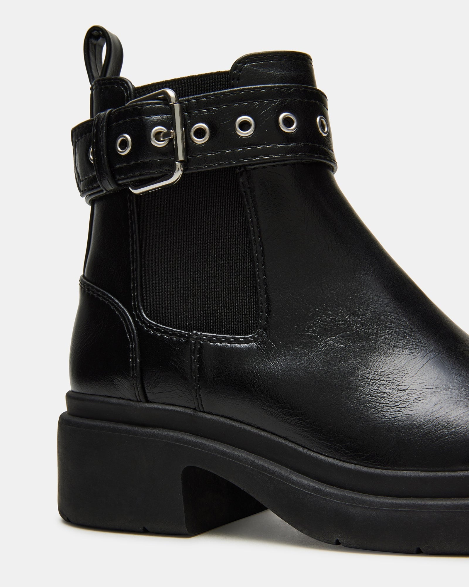 Kids boots styled with jeans for everyday schoolwear on urban sidewalks