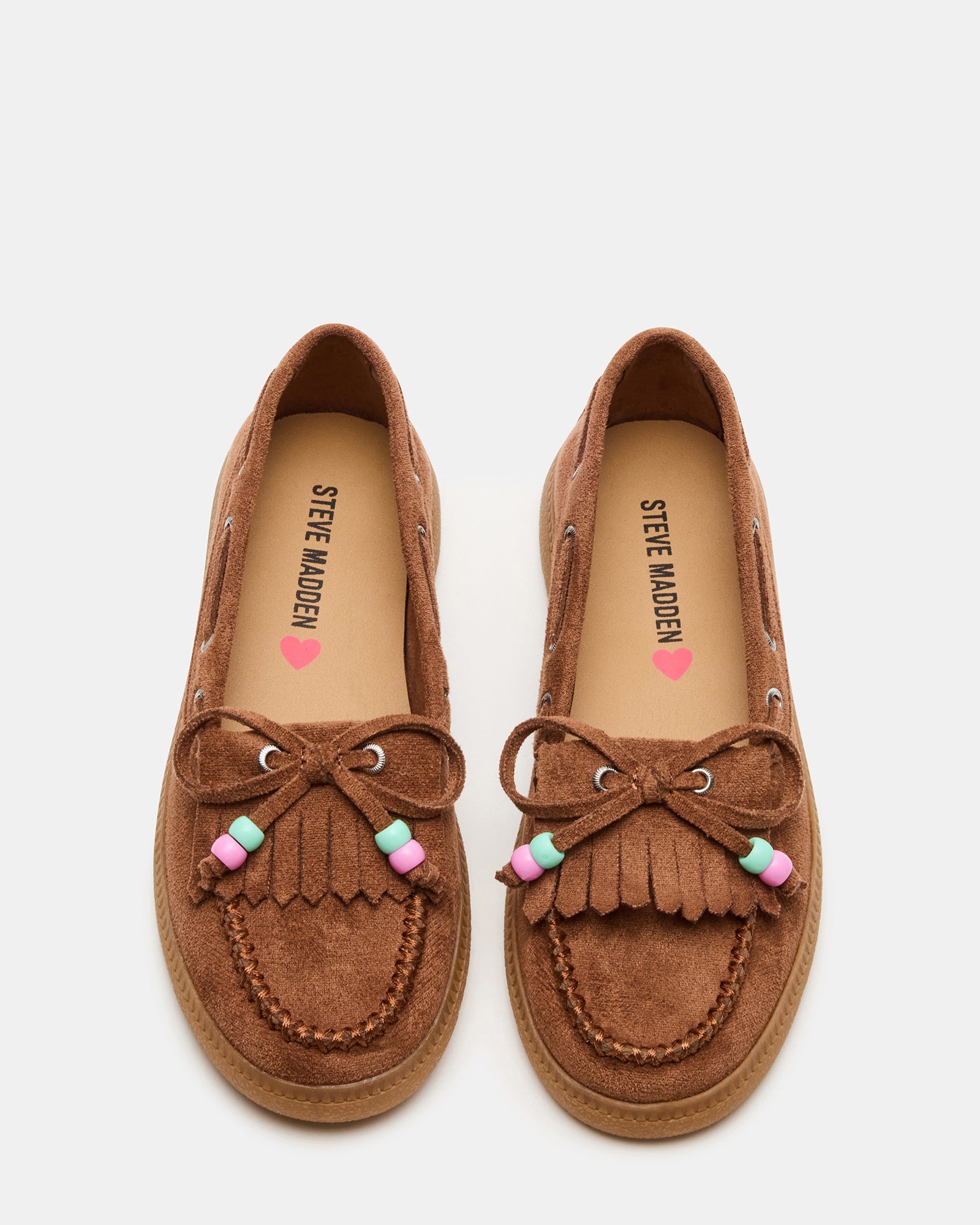 Side view of kids boat shoes showing fringe and bow detailing