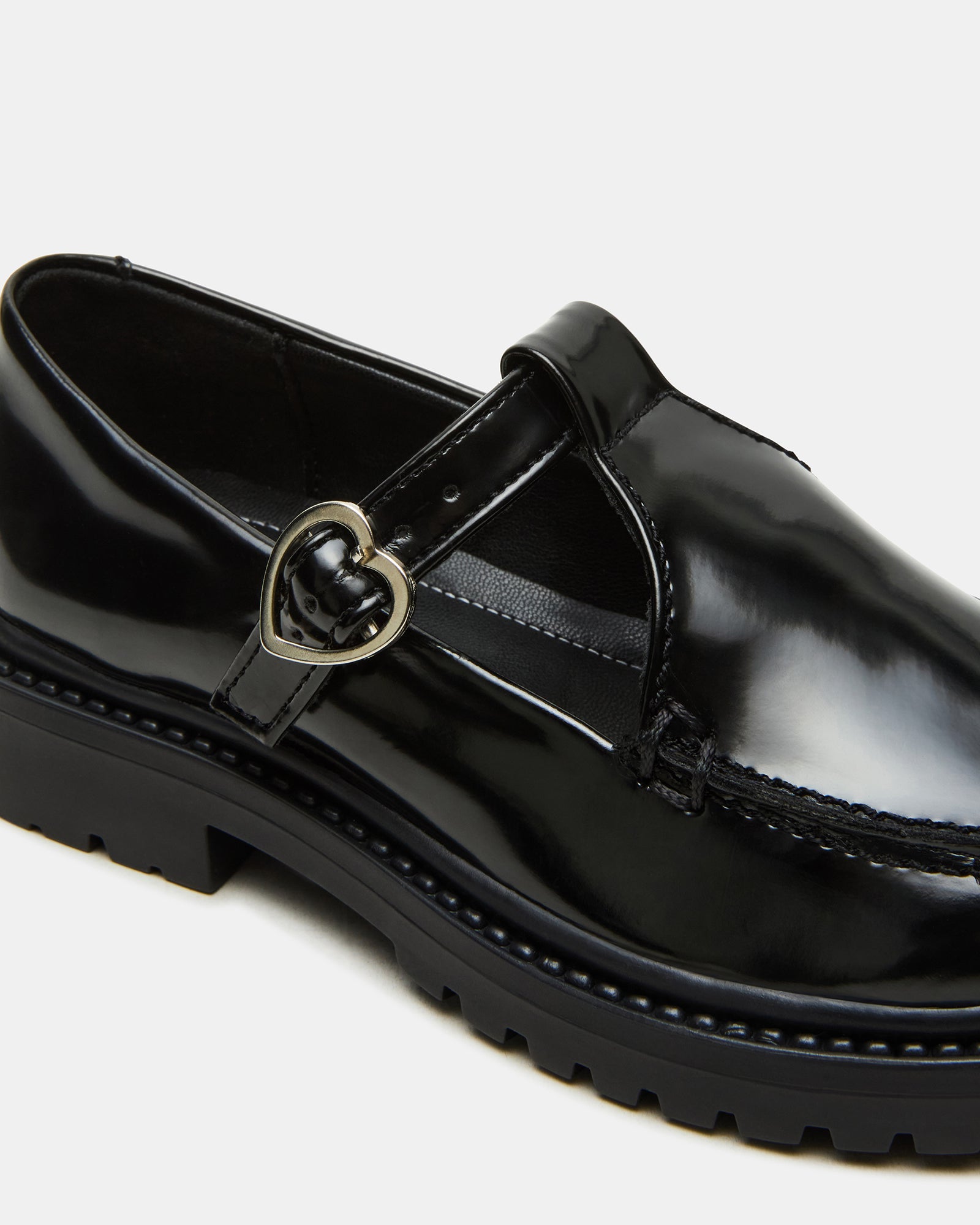 Kids black loafers paired with school uniform