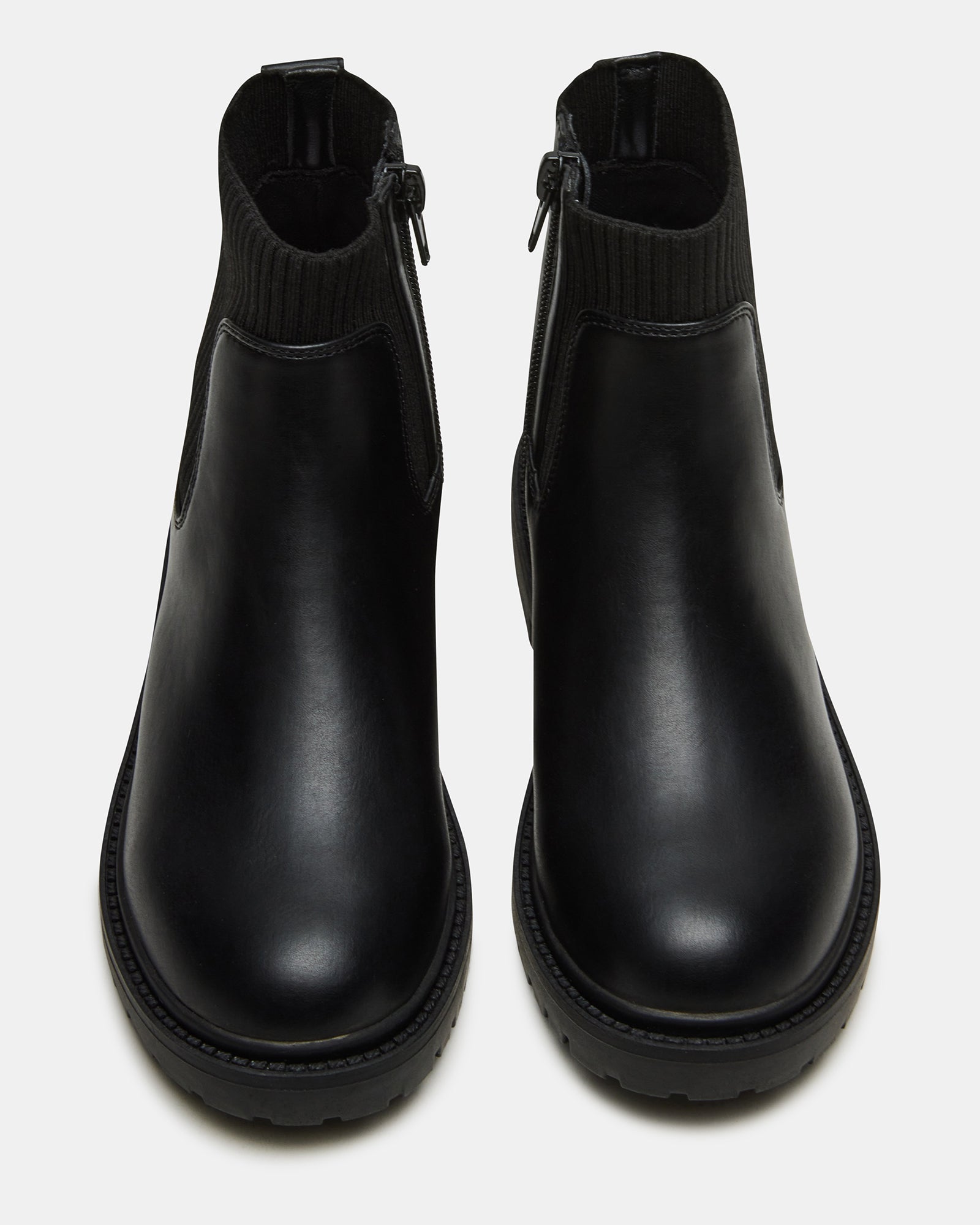 Kids black glitter ankle boots displayed on a wooden bench, showcasing the zip detail.
