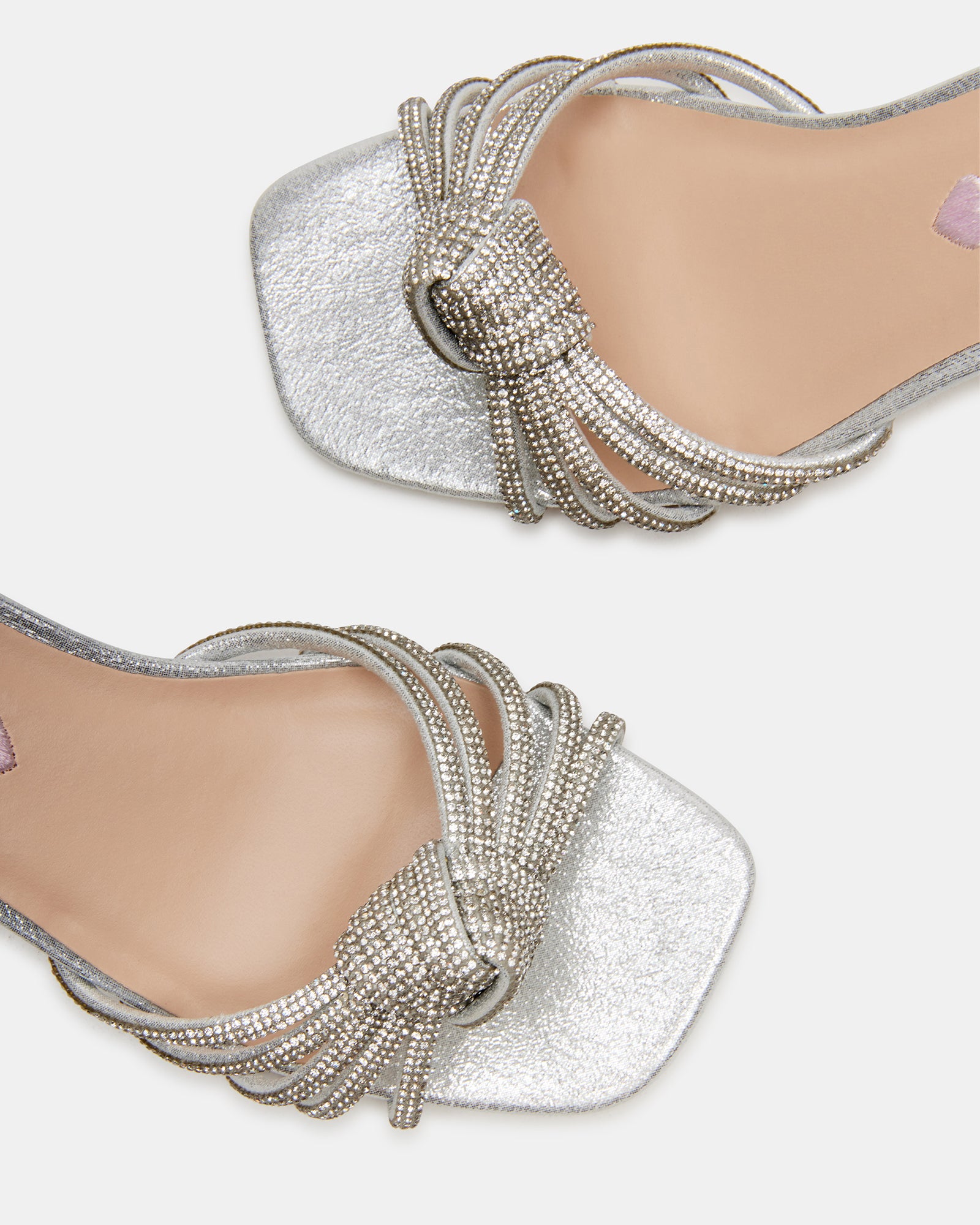 Girl wearing glittery silver dress shoes with a dress for a party