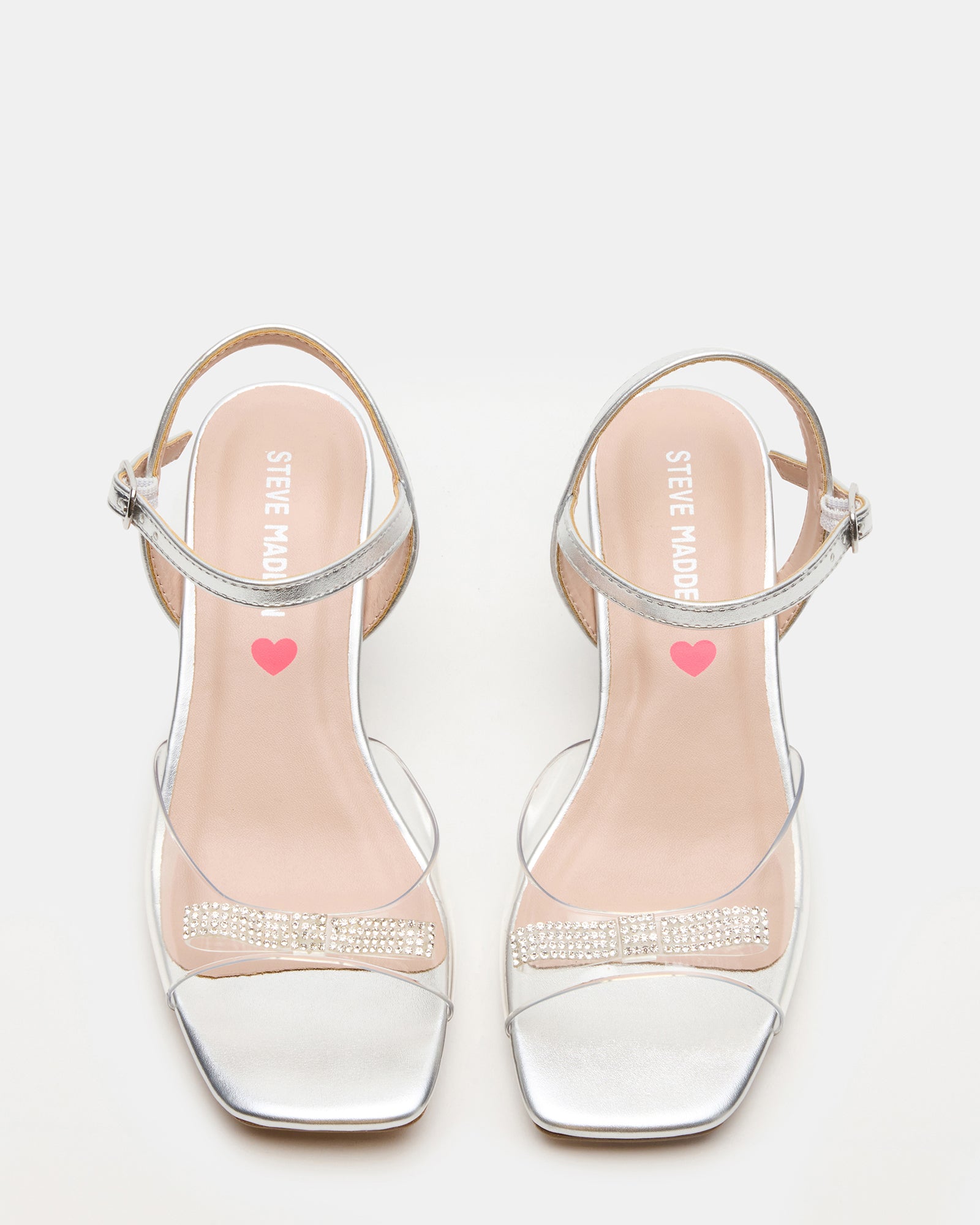Close-up of Merry Silver kids shoes showing rhinestone bow detail