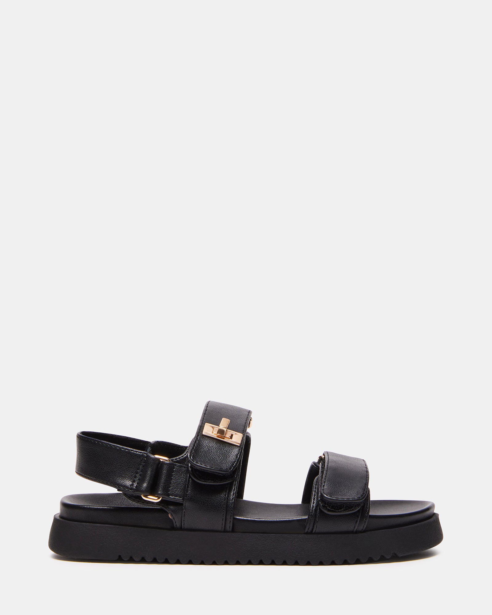 Side view of Mona Kids' Fashion Sandals in Black on grass.