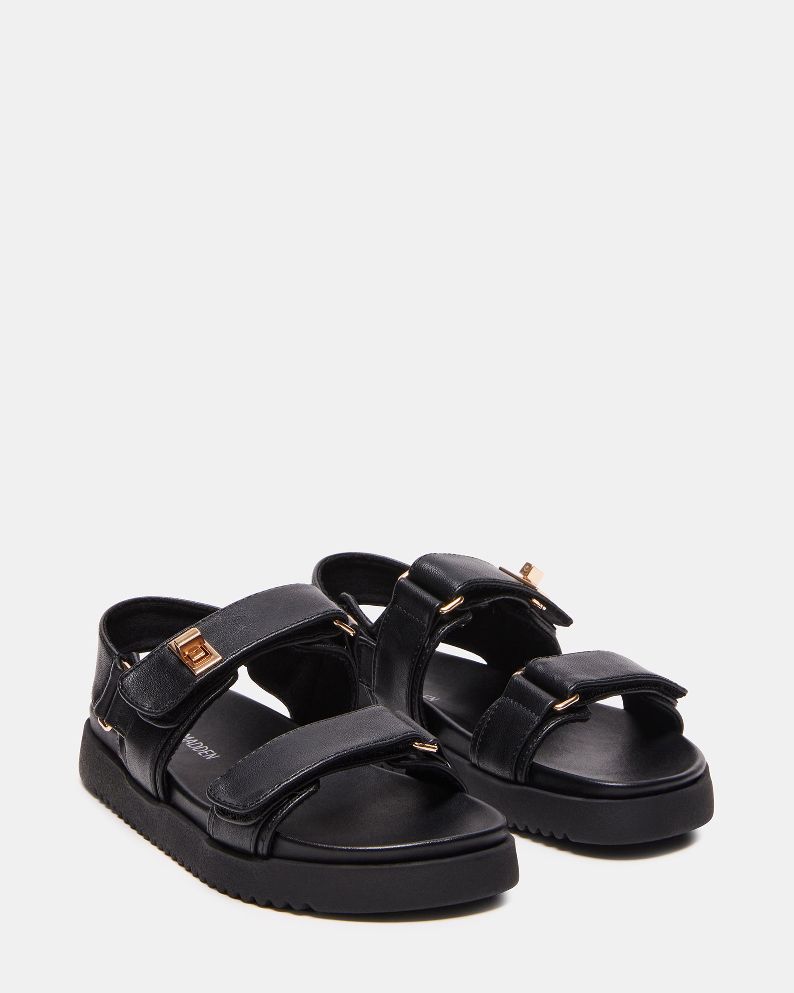 Mona Kids Sandals in Black worn at the beach.