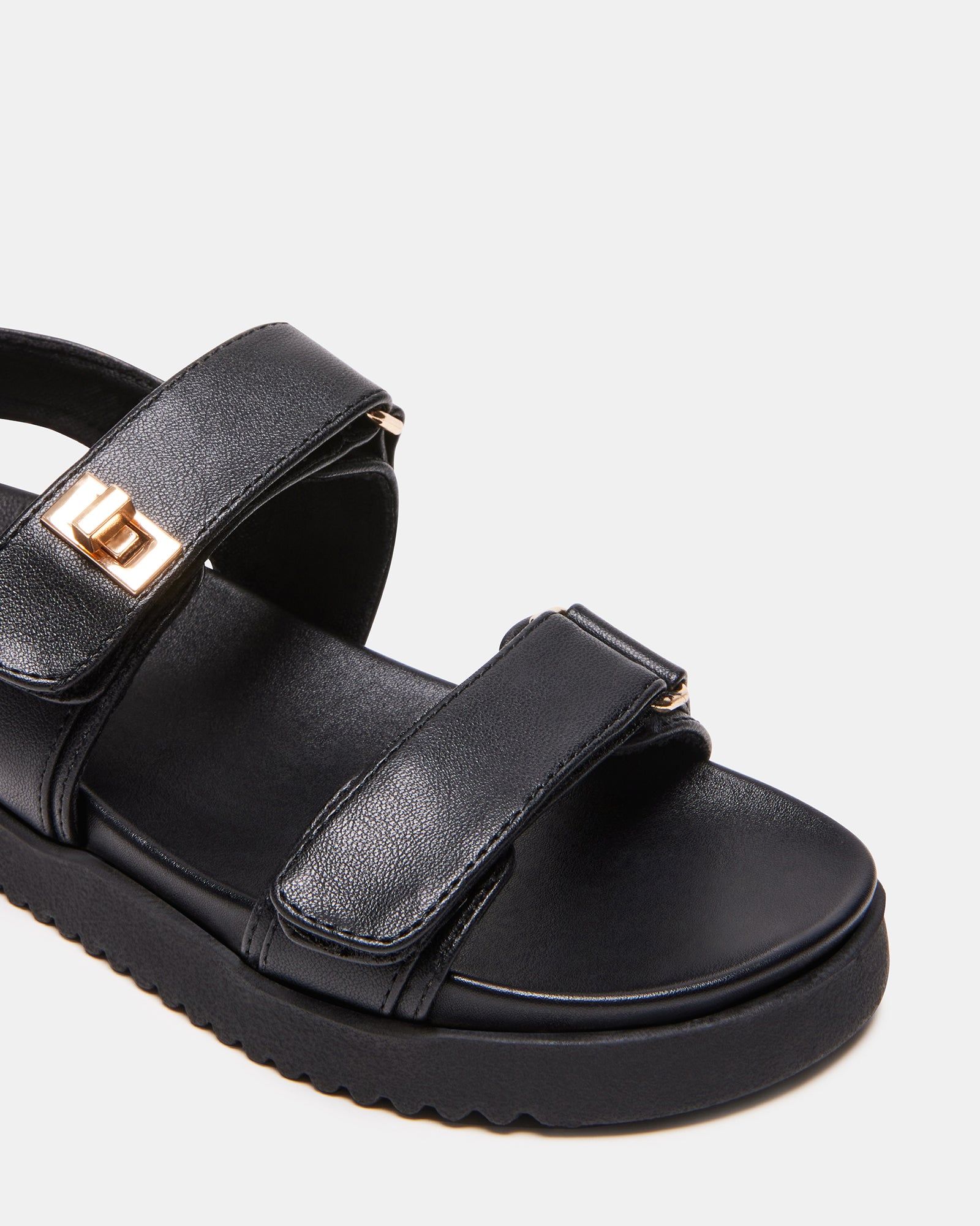 Mona Kids Sandals in Black worn at the beach.