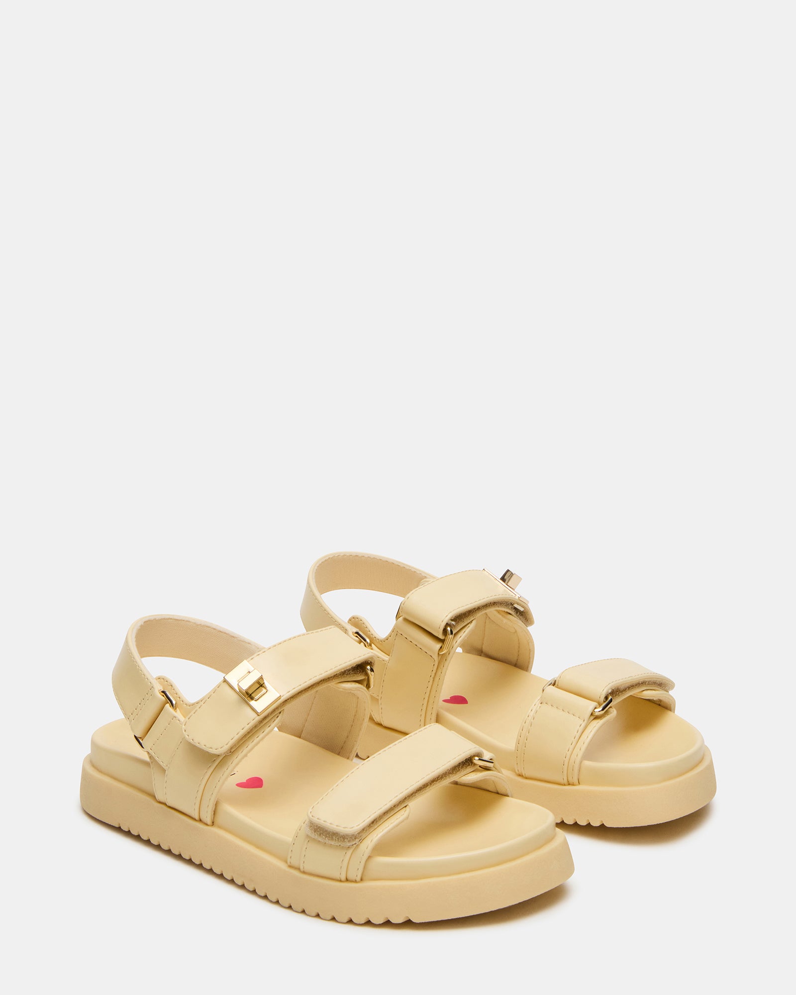 Overhead view of comfortable kids sandals with flatform soles, worn on warm day.