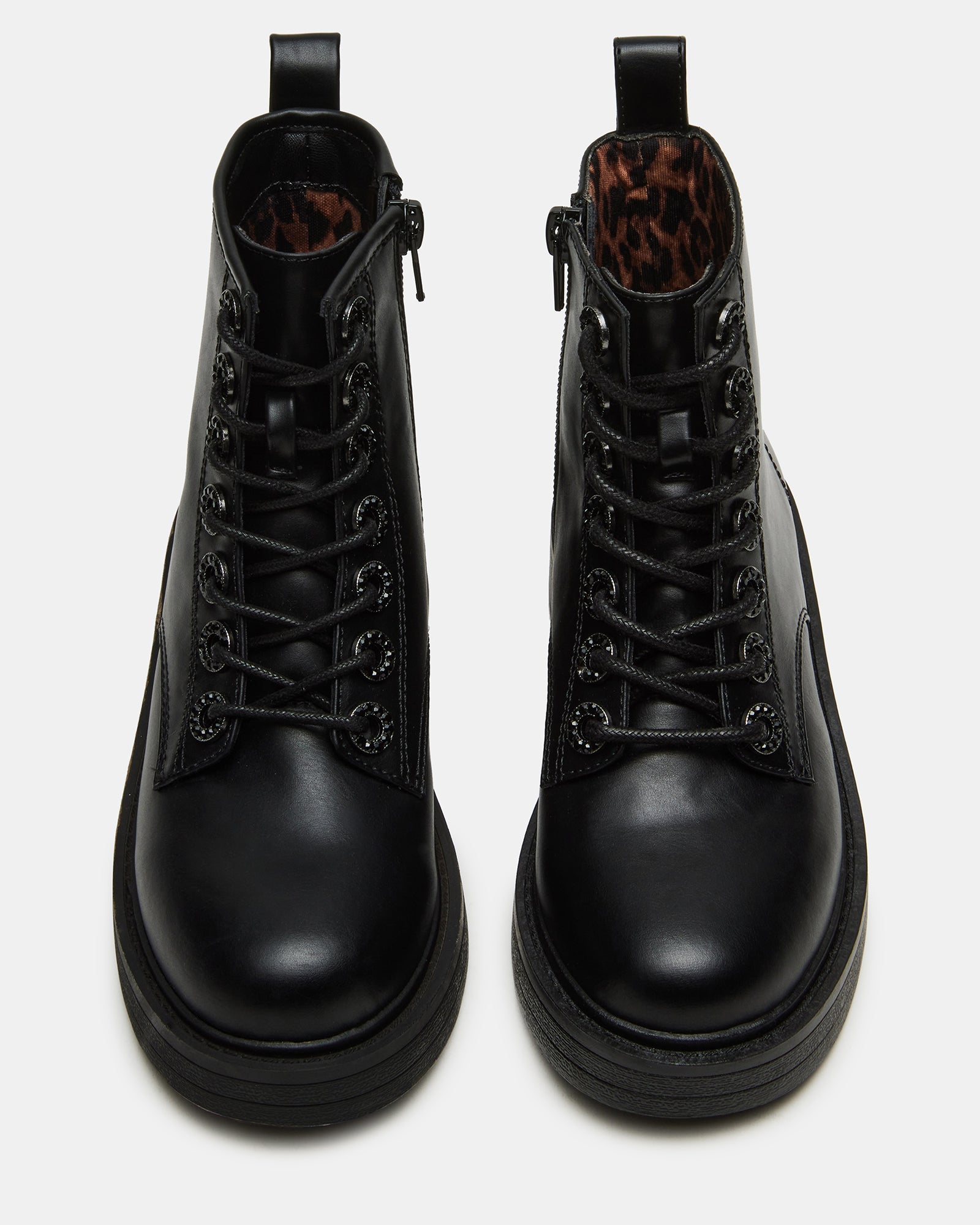 Kids wearing Nolita black combat ankle boots during outdoor play