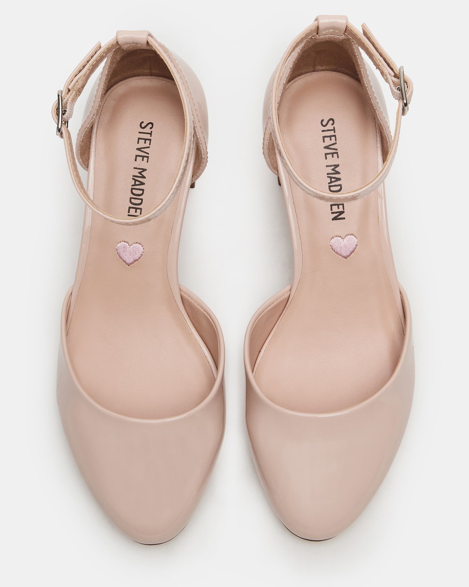 Girls blush patent dress shoes from a side angle, showing the ankle strap.