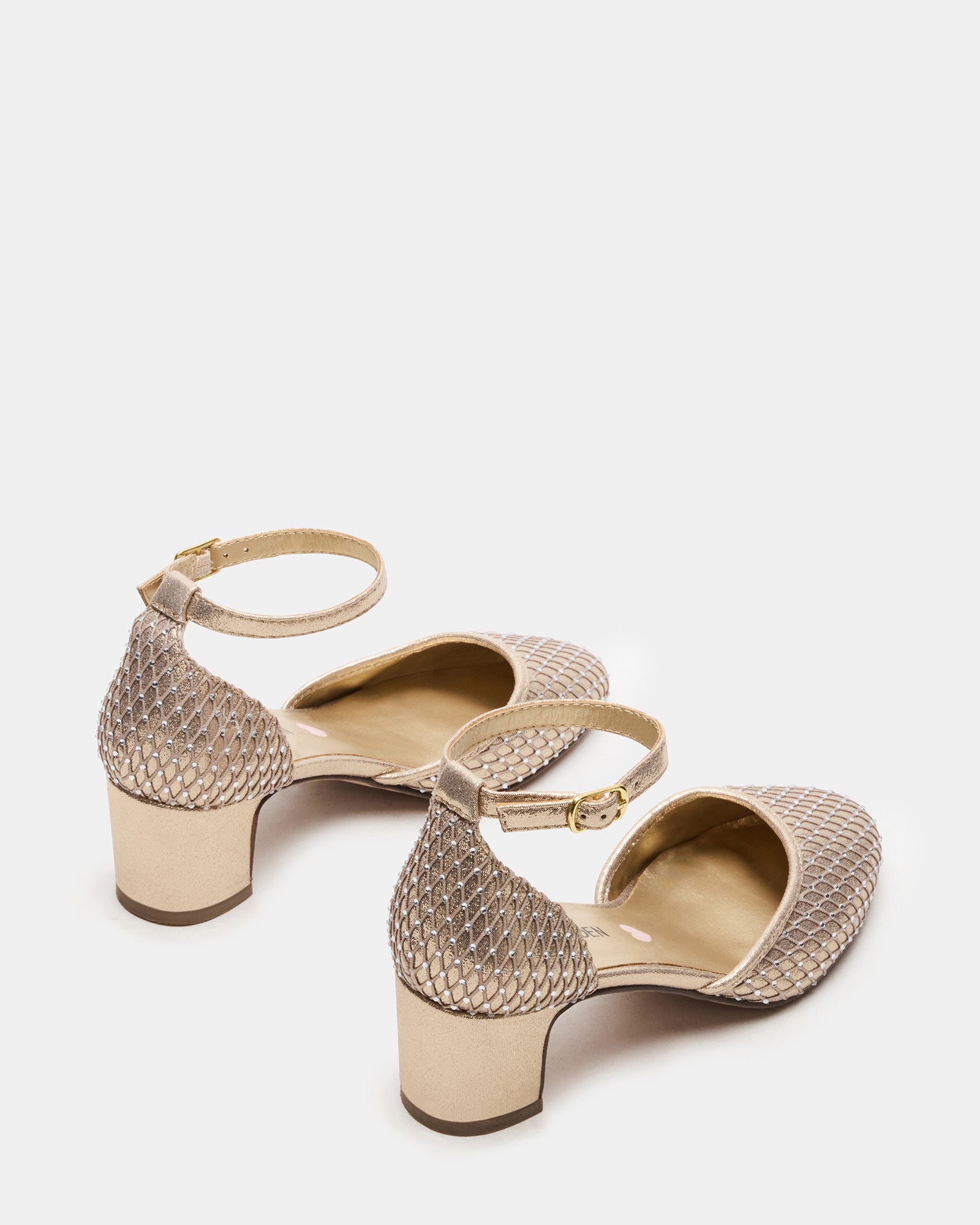Side view of stylish kids footwear featuring a supportive heel and gold finish