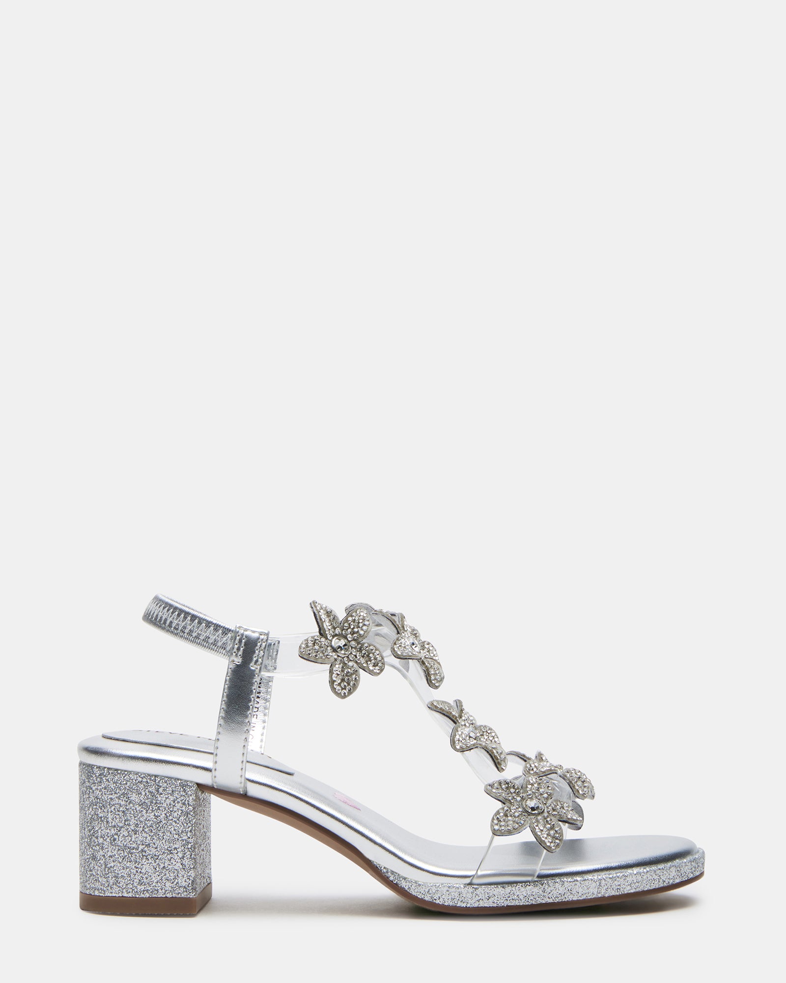 Close-up of silver kid shoes with rhinestone flowers on strap