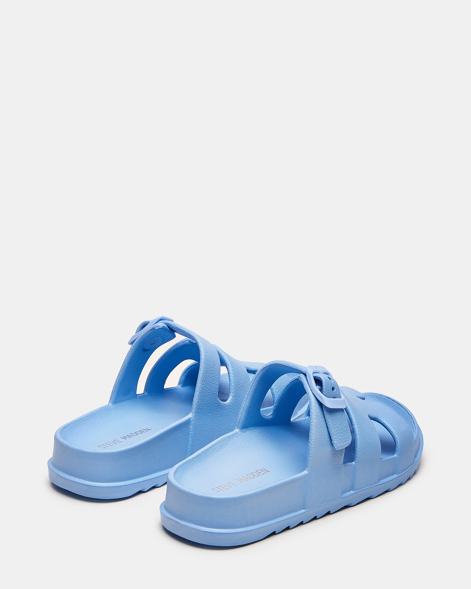 Side view of blue slide sandals highlighting 1.5 inch heel and textured sole