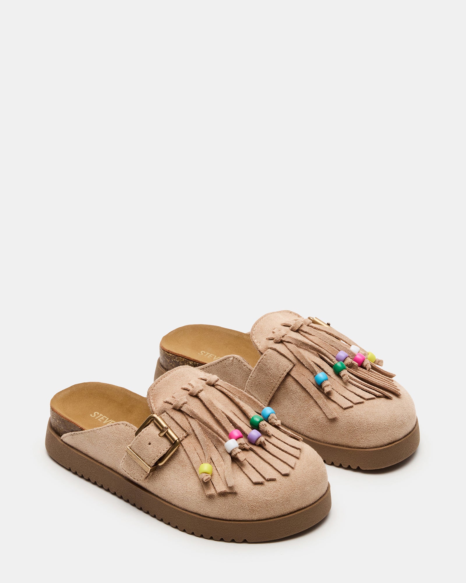 Little girl wearing bohemian flats in taupe with a casual dress for outdoor play