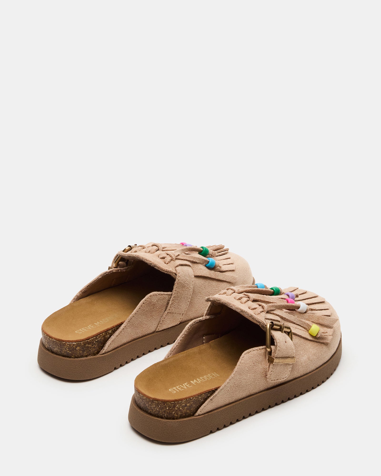 Little girl wearing bohemian flats in taupe with a casual dress for outdoor play