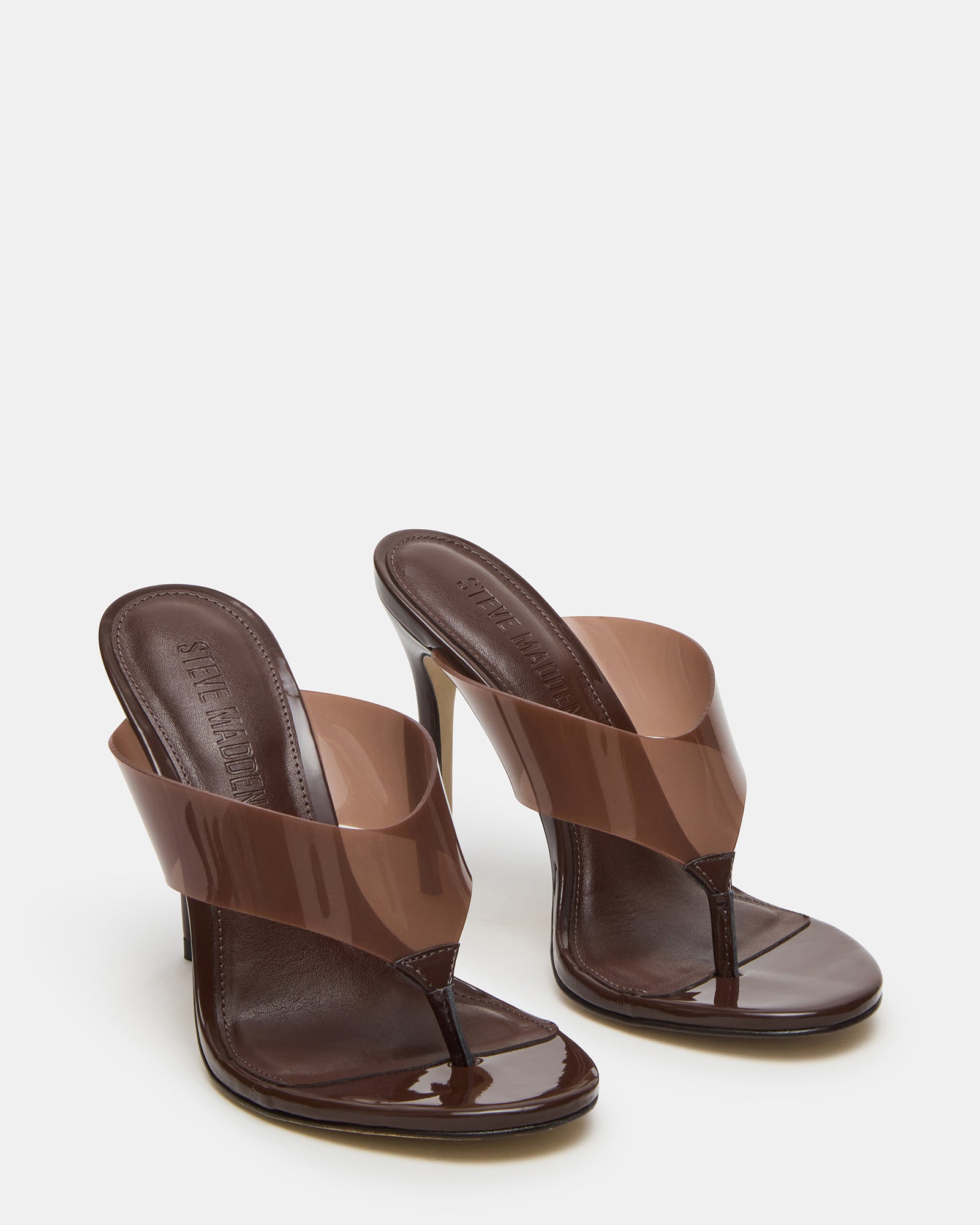 Model wearing stylish mules at a casual outdoor event, demonstrating versatility.