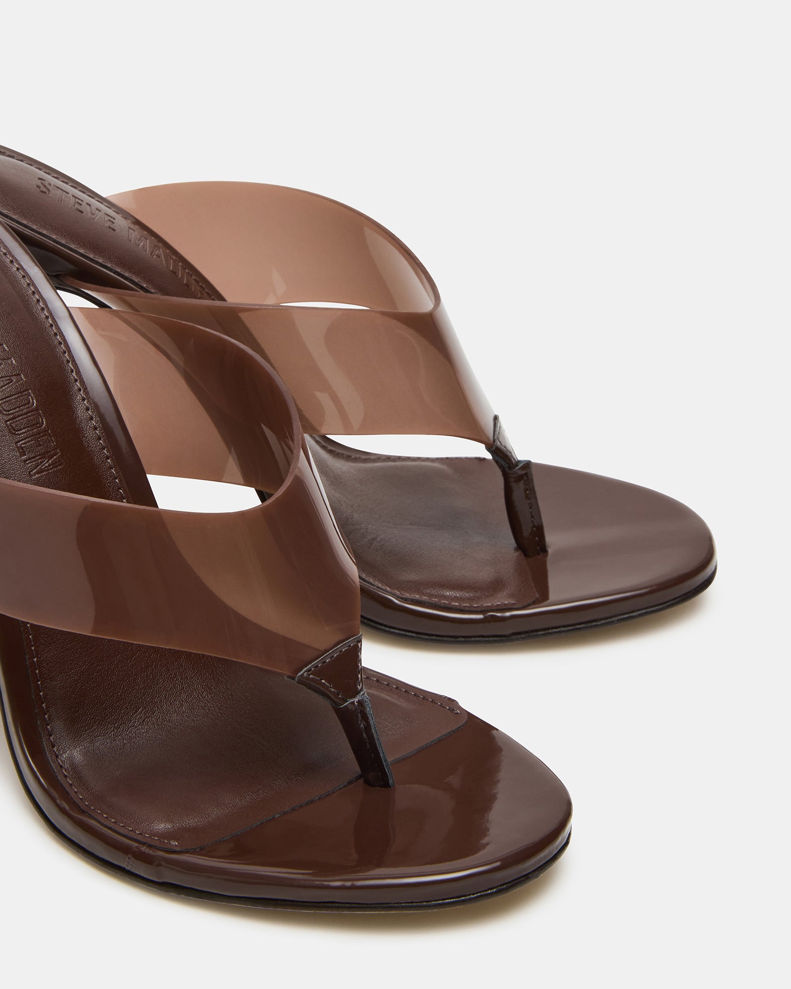 Elegant thong mules heels displayed on a minimalist background, highlighting their chic look.
