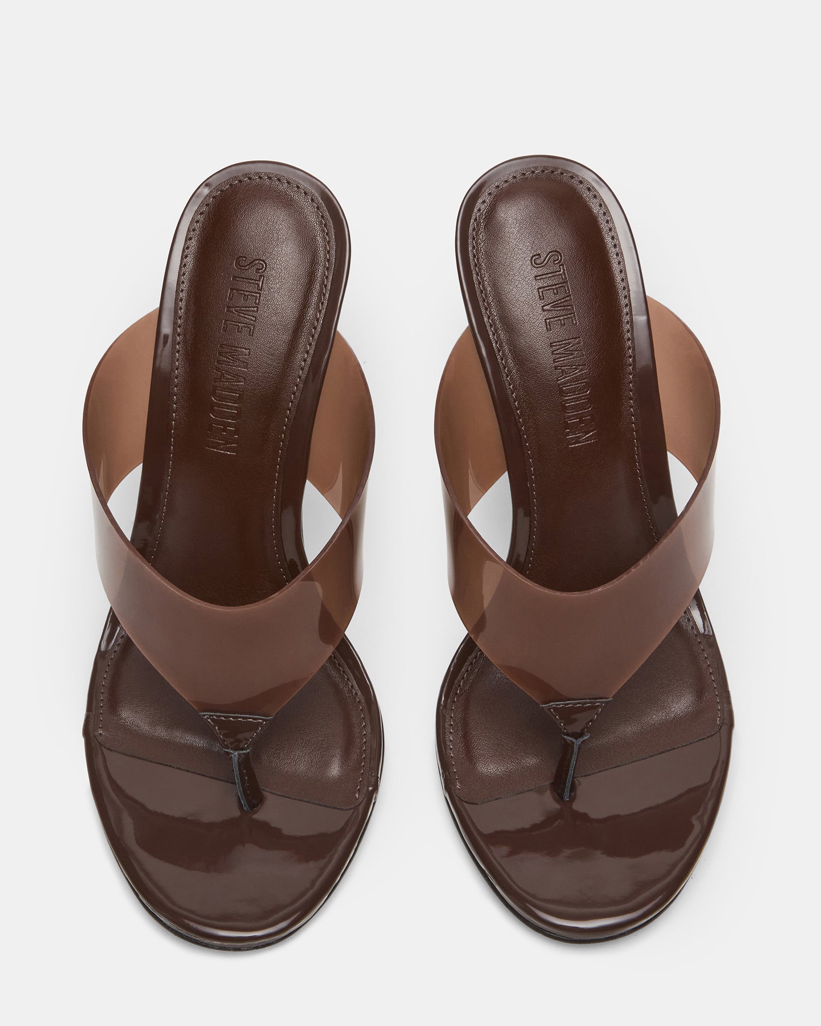 Close-up of elegant thong-heeled mules in brown, showcasing design details.