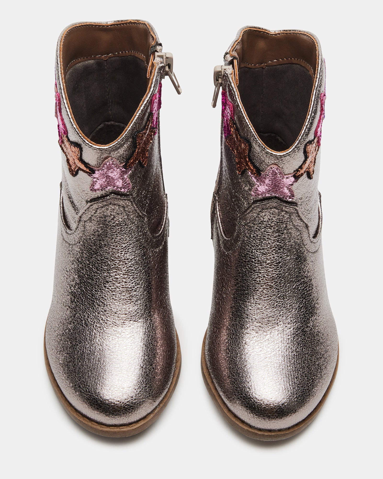 Toddler wearing starry Western ankle boots outdoors in winter.