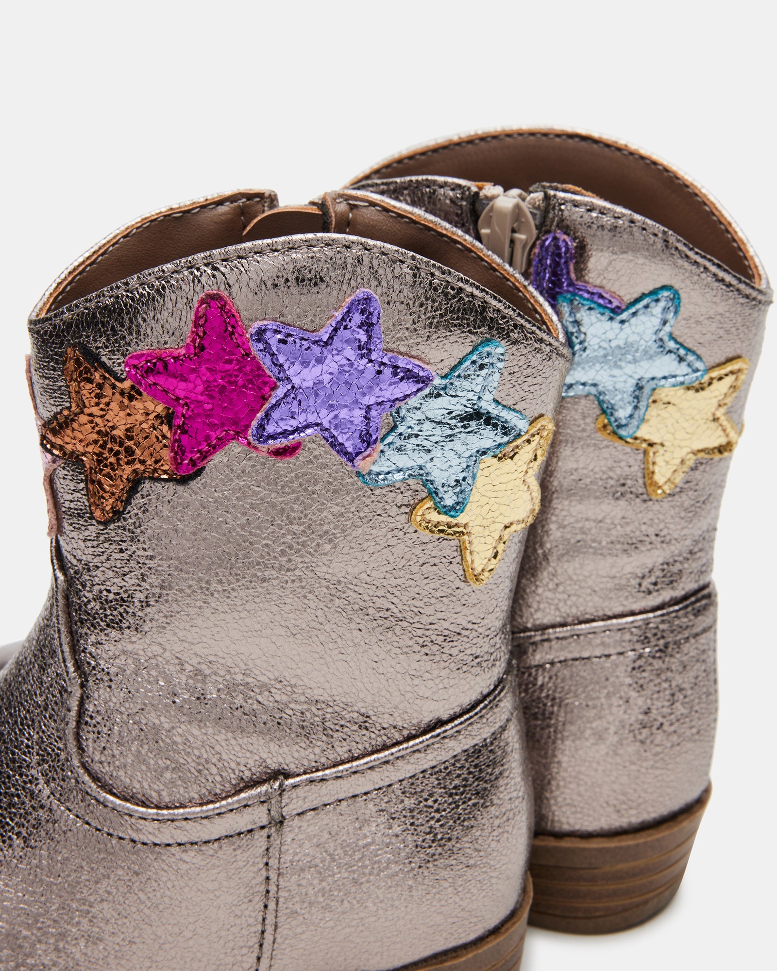 Toddler playing in the snow while wearing trendy toddler snow boots.