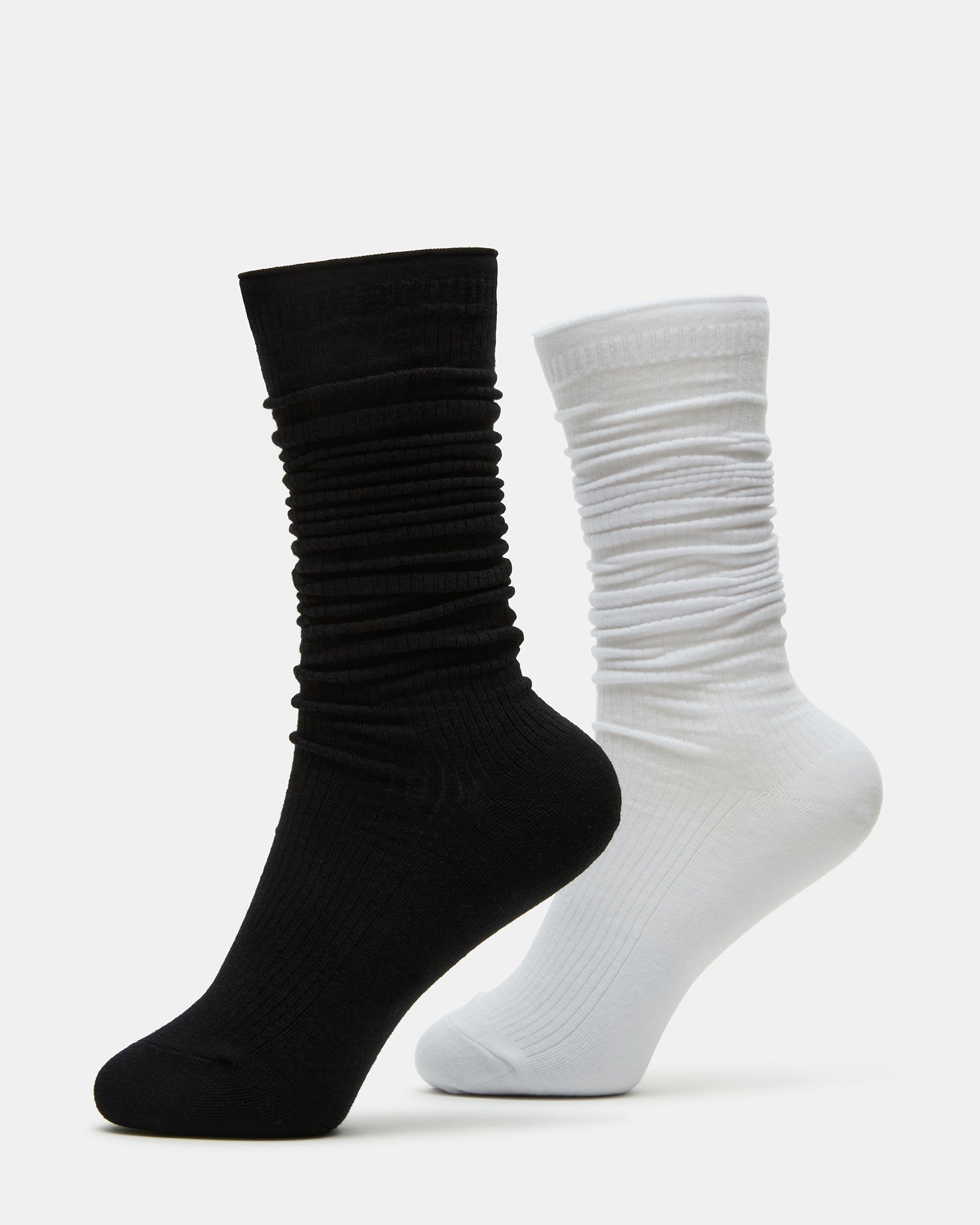 Side-by-side view of black and white striped socks on wooden surface
