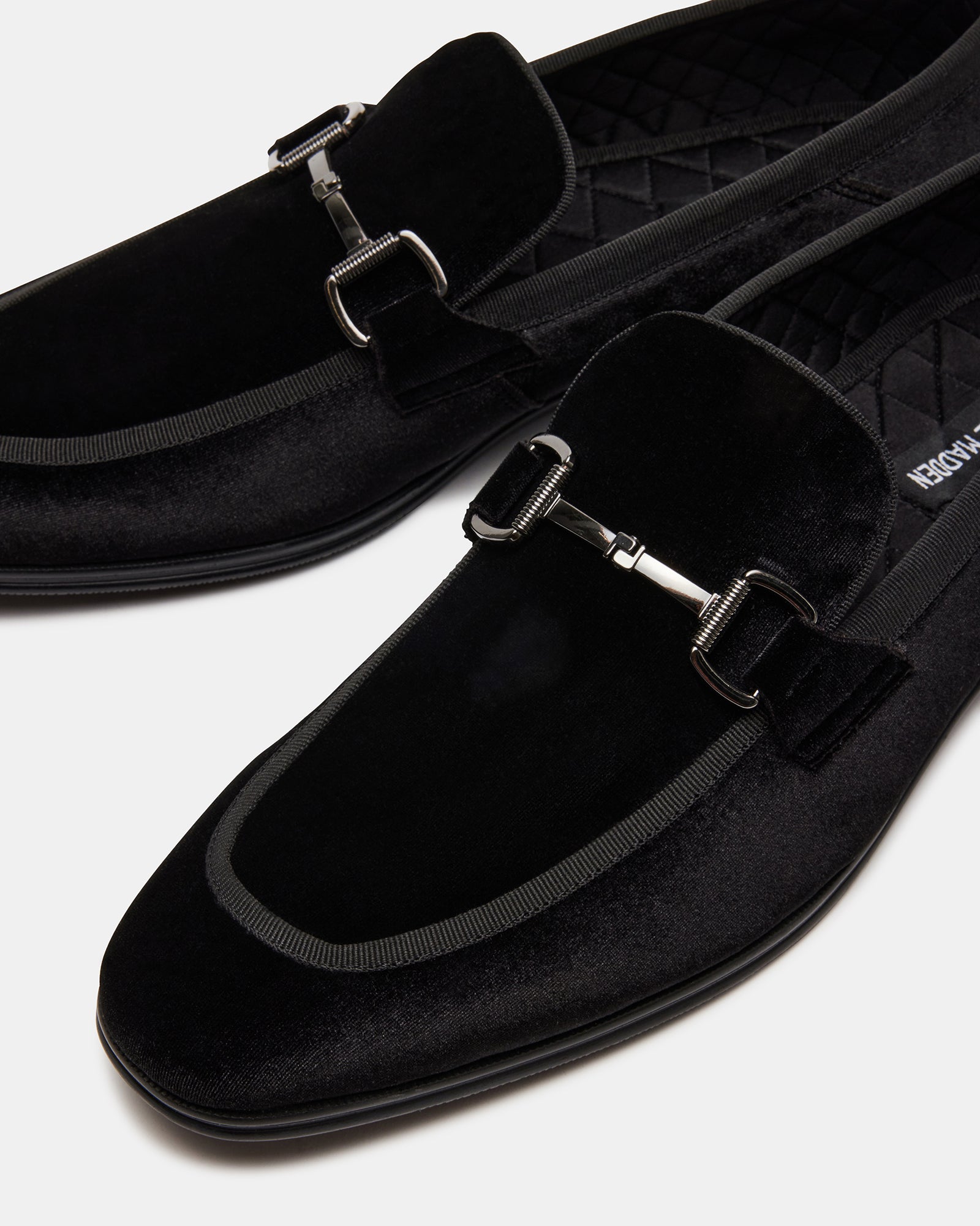 Close-up of black silver shoes with textile lining and rubber sole