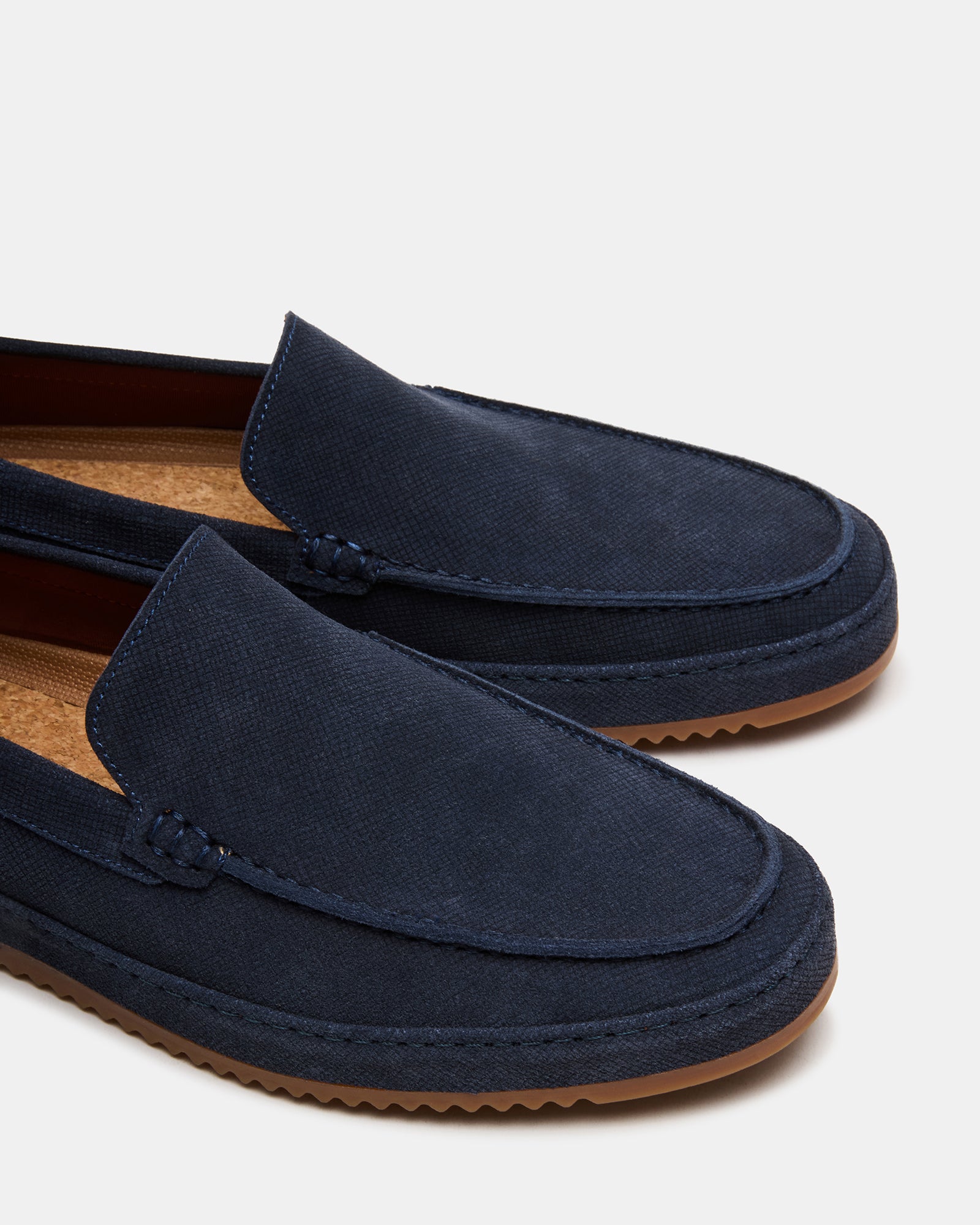 Elegant navy suede loafers paired with formal attire for women