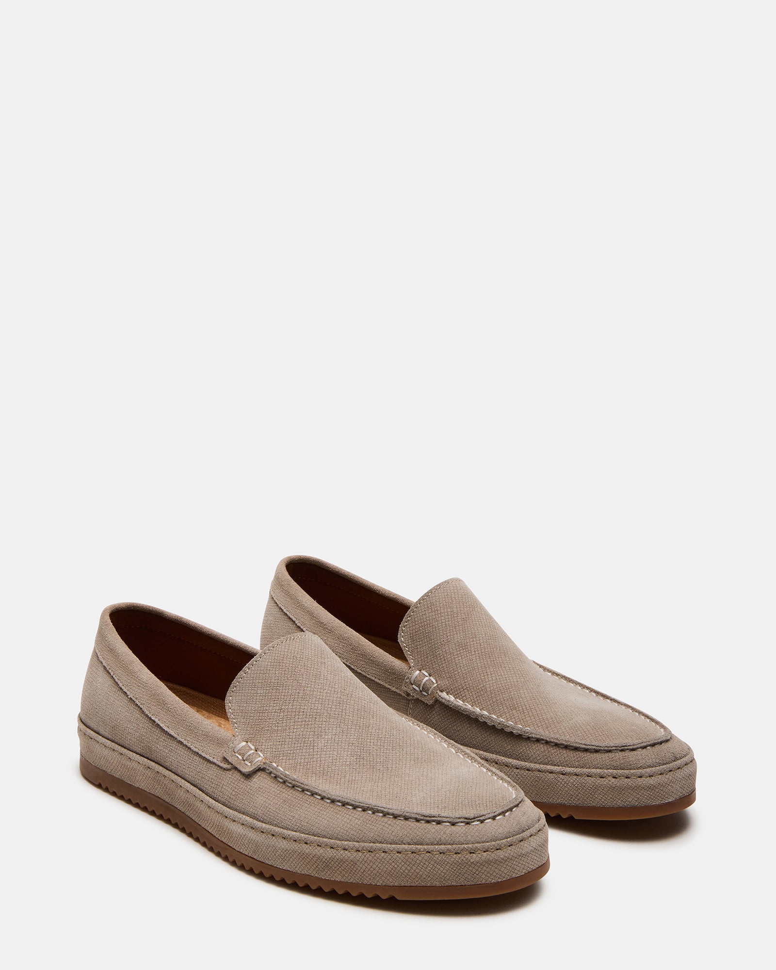 Side view of slip-on loafers paired with tailored trousers