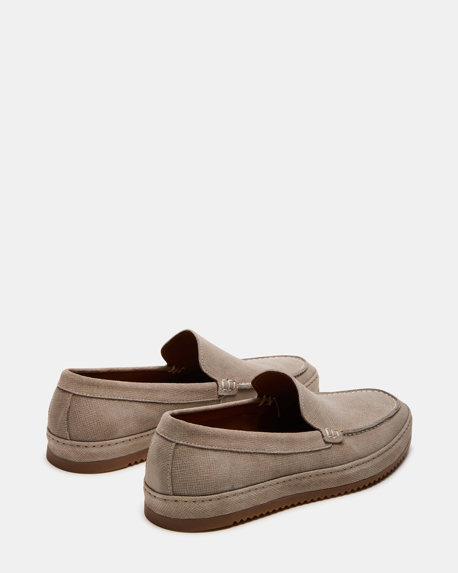 Side view of slip-on loafers paired with tailored trousers