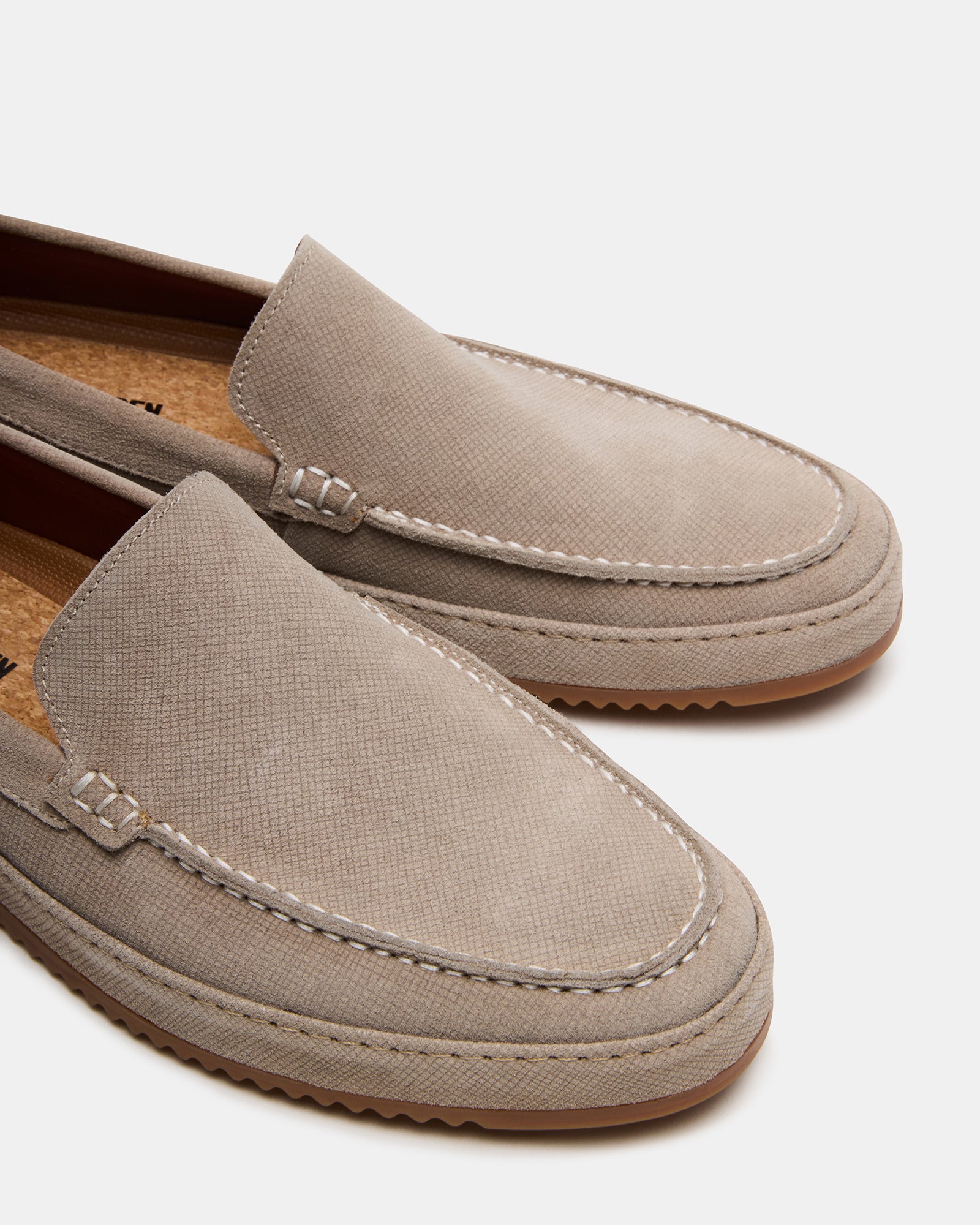 Lifestyle shot of mens suede loafers worn with denim for a relaxed look