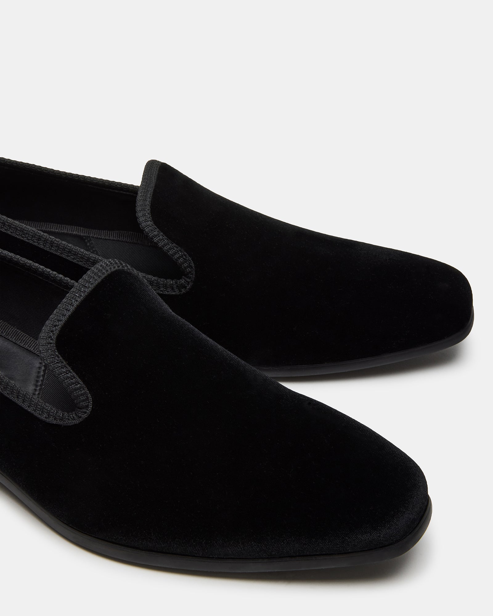 Elegant black velvet loafers for men, showcasing slip-on style.