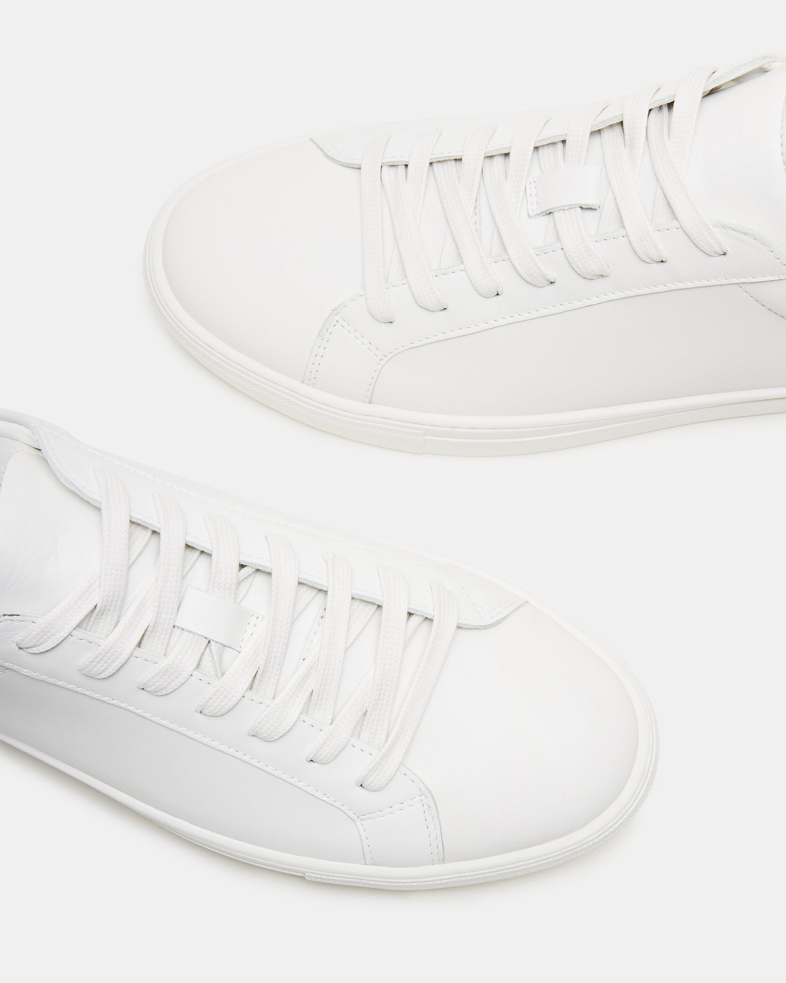 Bottega white leather sneakers from the side, highlighting the lace-up design.