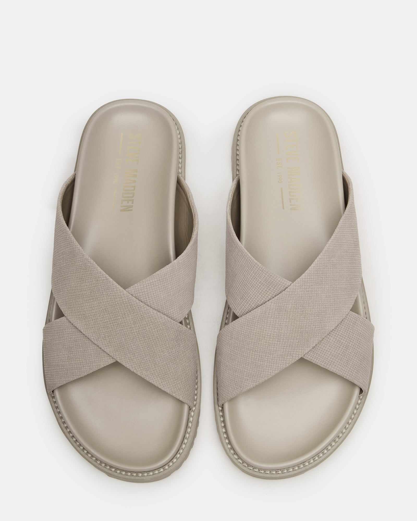 Gold flat sandals with crisscross design, perfect for summer outings.