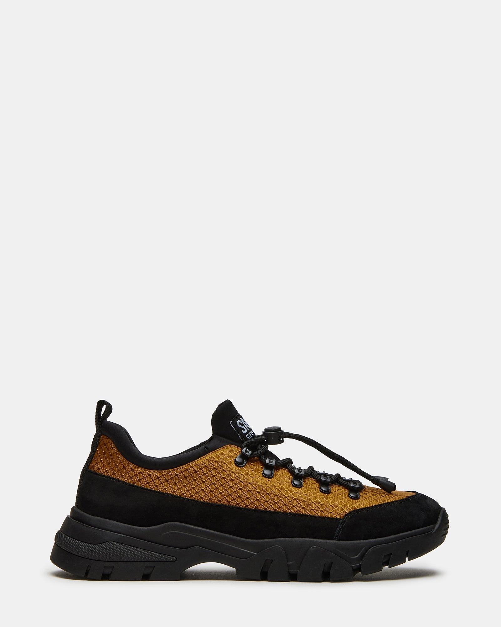 Chasley Mustard hiking sneakers side view on rocky terrain