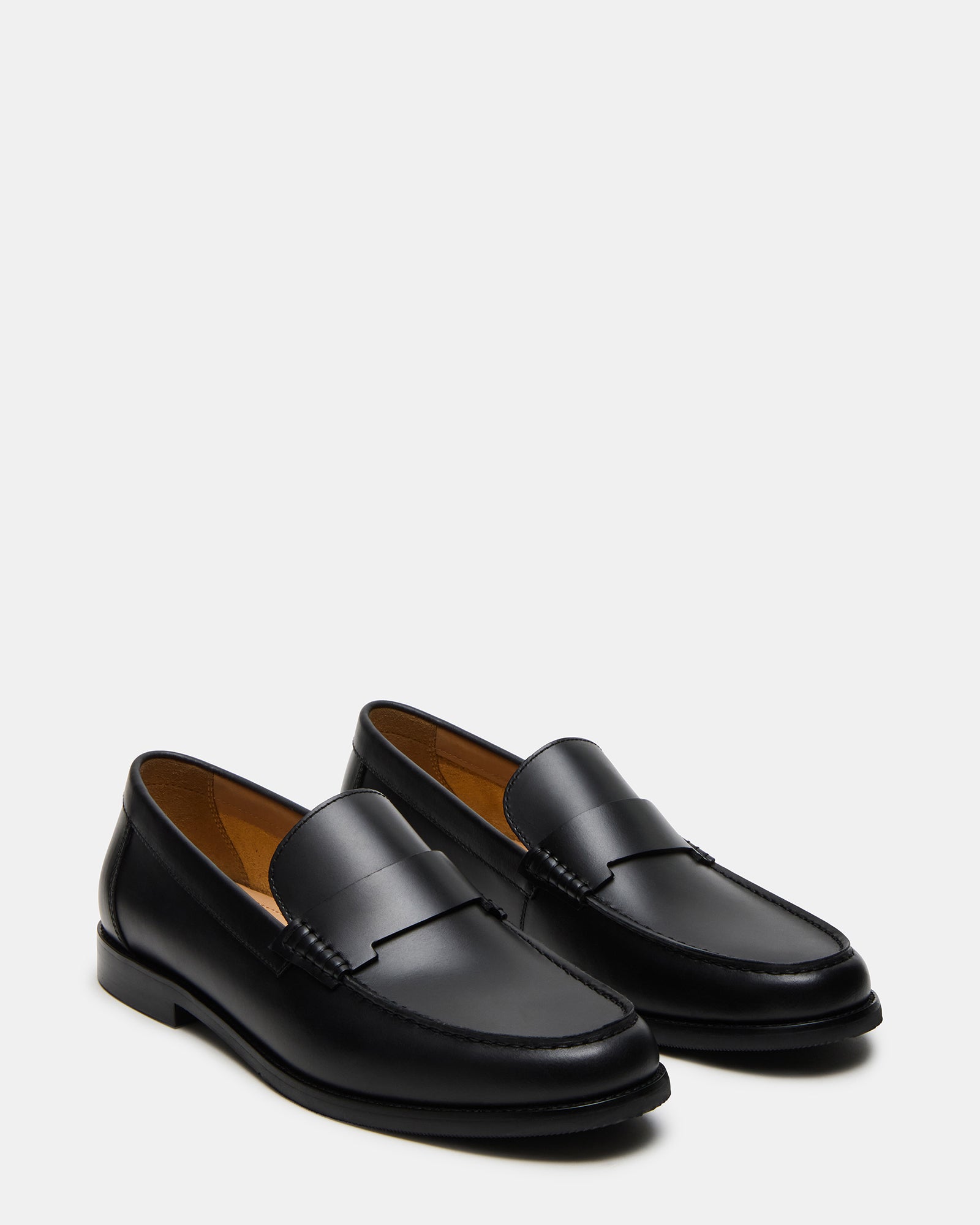 Lifestyle shot of mens loafers worn with chinos on New York sidewalk