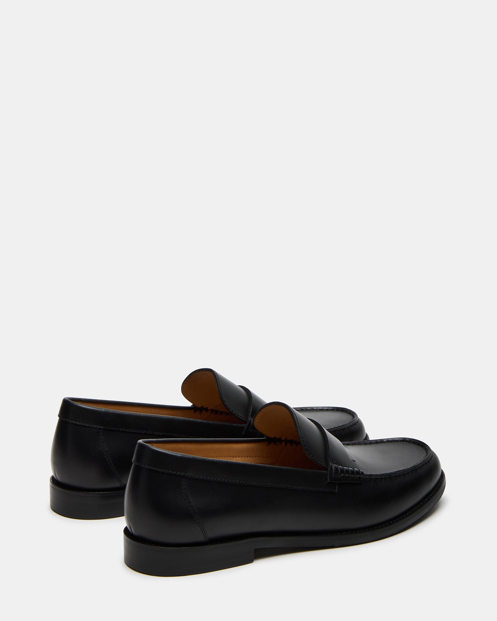 Lifestyle shot of mens loafers worn with chinos on New York sidewalk