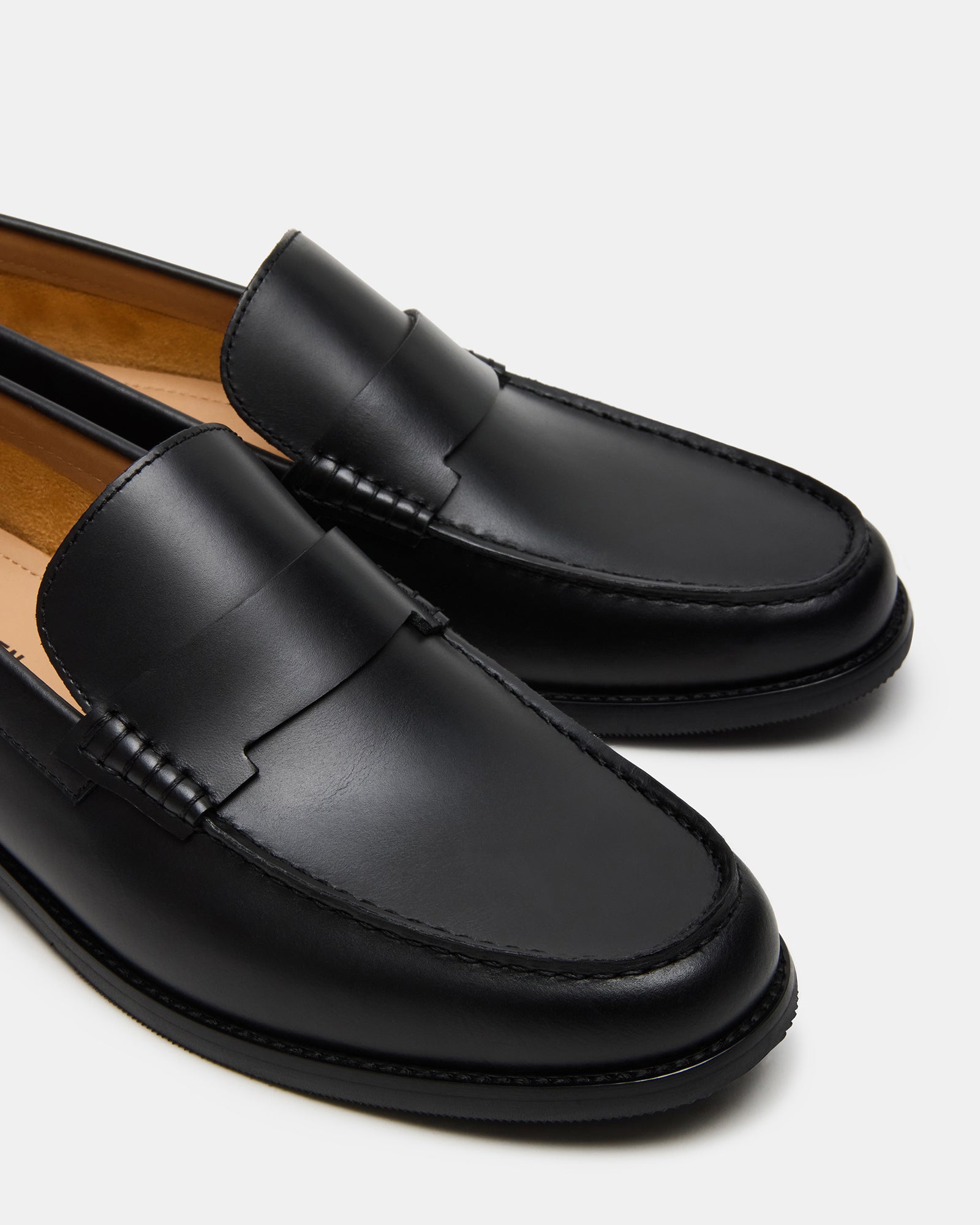 Side view of slip-on penny loafers with rubber sole, ideal for business travel