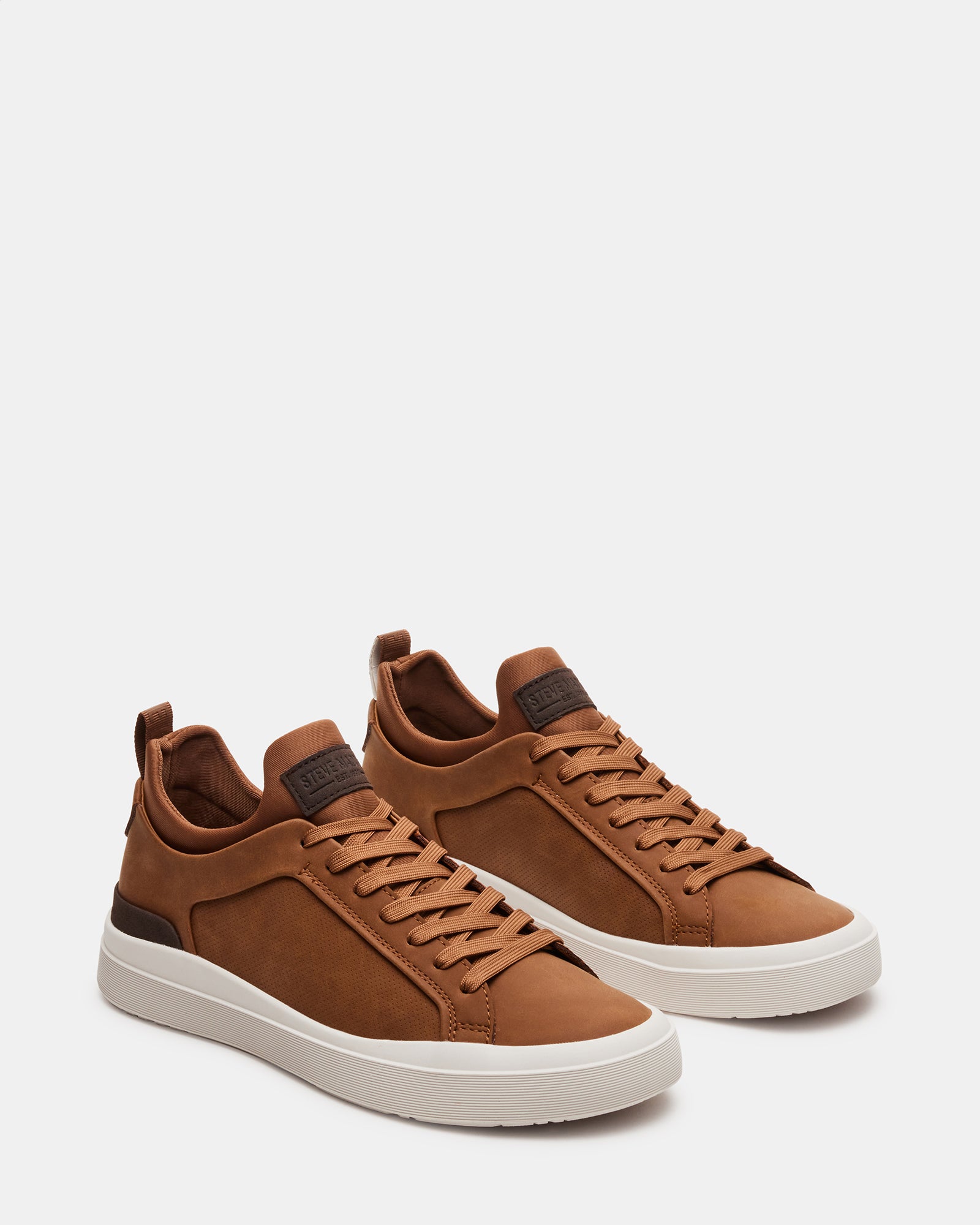DACK mens slip on sneakers worn casually with jeans in an urban setting.