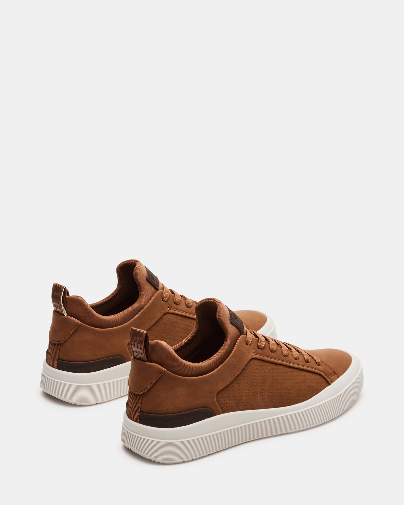 DACK mens slip on sneakers worn casually with jeans in an urban setting.